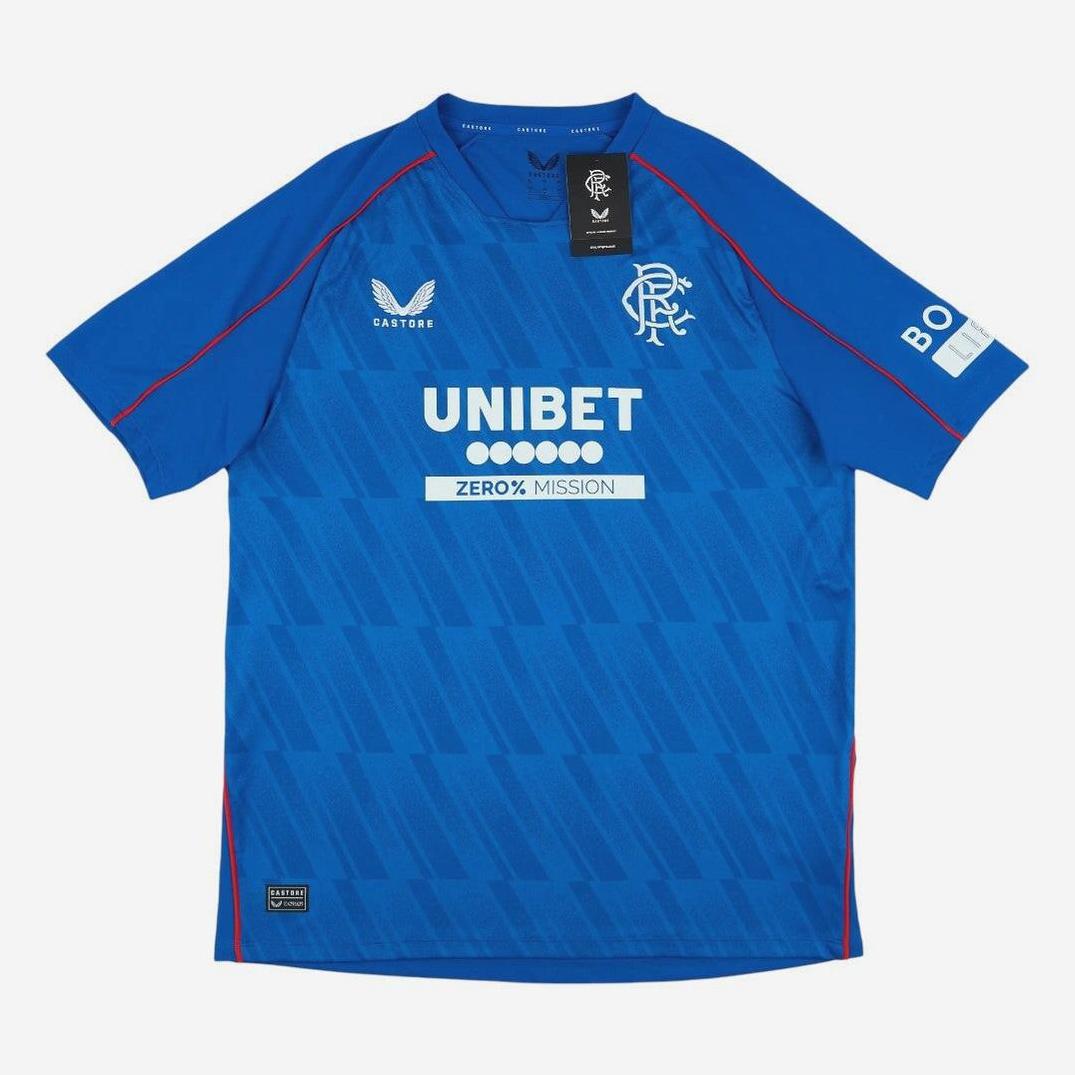 The Rangers F.C. 2024-25 Home Shirt by Retro1999 is a blue short-sleeve kit with red accents, club crest, Castore logo, and UNIBET and BO sponsors—ideal for any fan’s collection and shown flat on a white background.