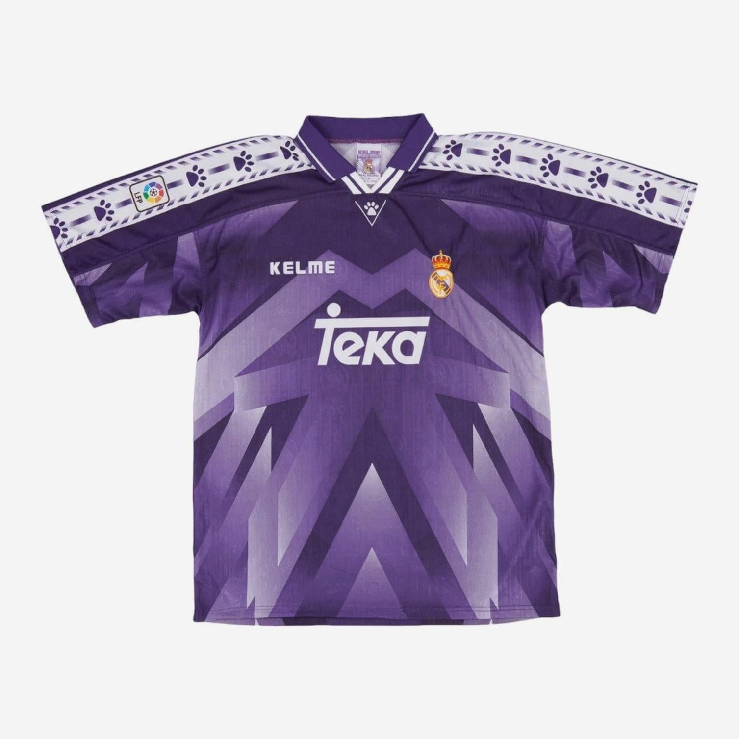 The Real Madrid 1996-97 Away Shirt by Retro1999 features purple geometric patterns, white accents, Kelme and Teka logos, club crest on the chest, and paw print motifs on the sleeves—a classic piece of football history.