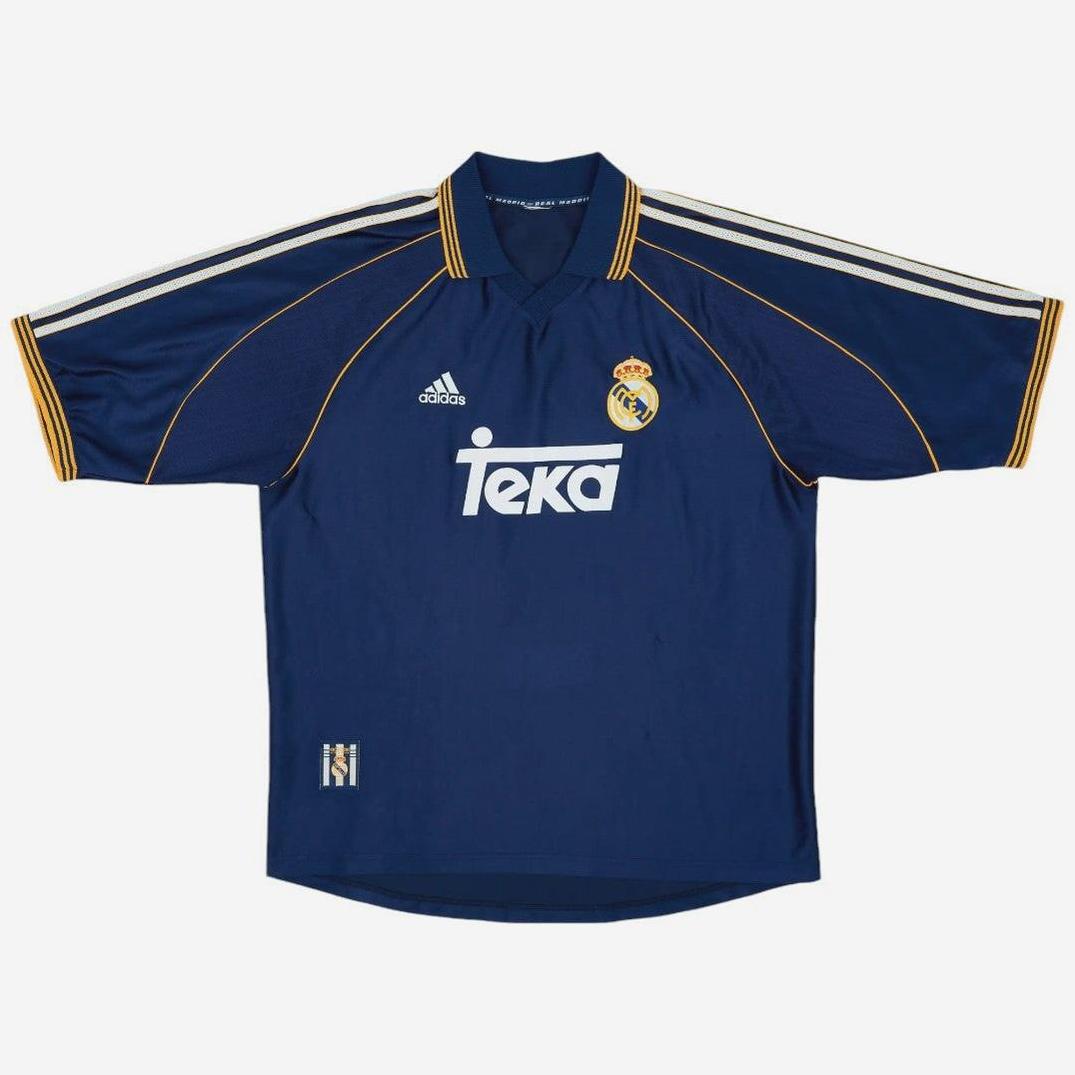 The Retro1999 Real Madrid 1998-99 Third Shirt features navy blue fabric with yellow trim, white Adidas stripes, Adidas logo, TEKA sponsor, and club crest—delivering a classic retro look in premium quality material.