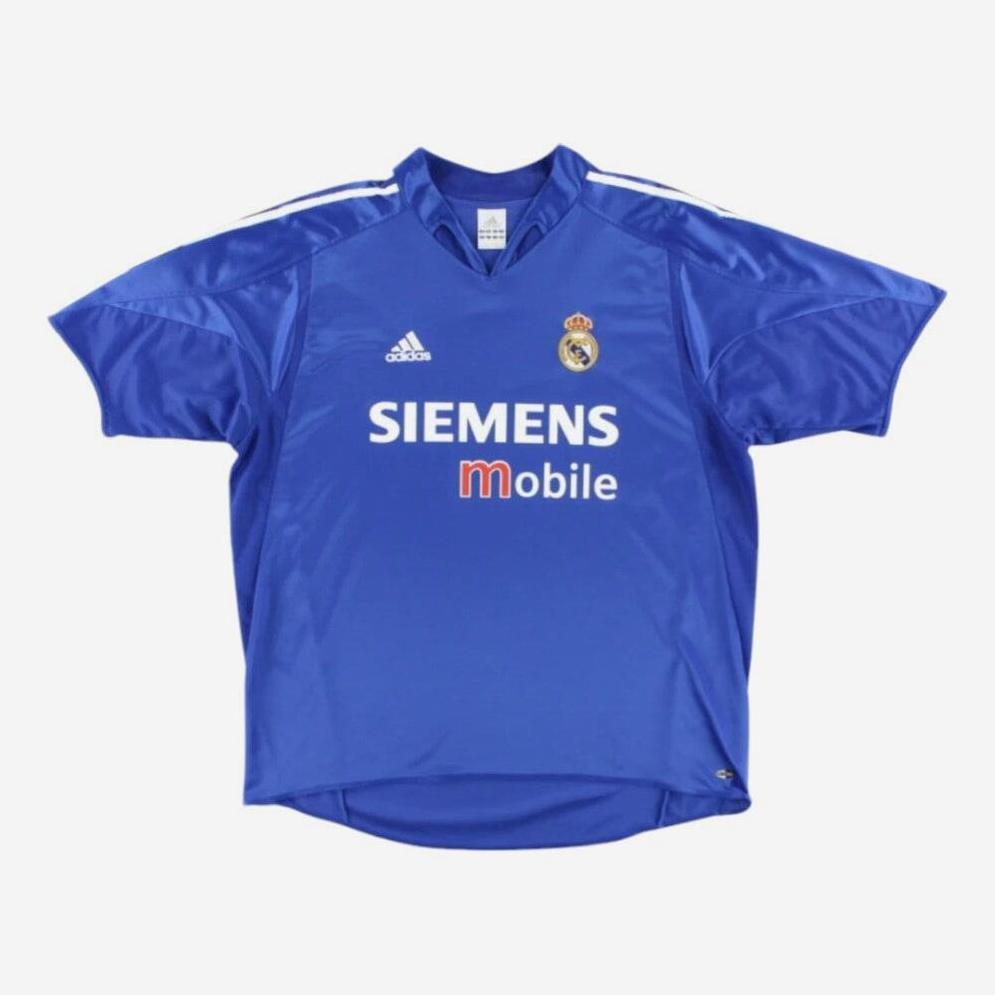The Retro1999 Real Madrid 2004-05 Third Shirt is a blue retro kit with white stripes, featuring the club crest, Adidas logo, and SIEMENS Mobile sponsor on the front.