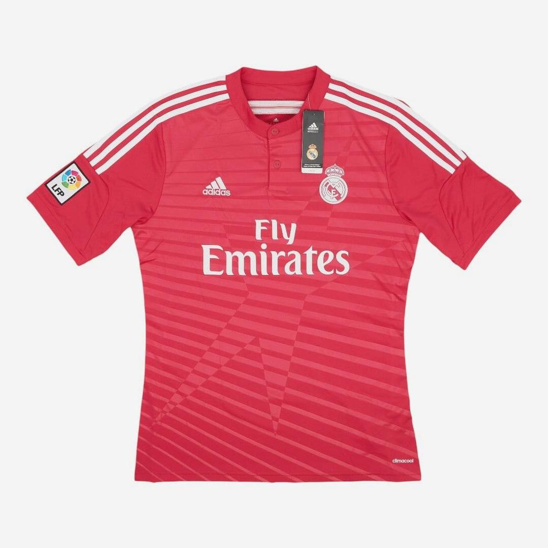 The Retro1999 Real Madrid 2014-15 Away Shirt is red with white shoulder stripes and logos, “Fly Emirates” sponsor, and a La Liga patch on the right sleeve—a stylish retro kit from an iconic season.