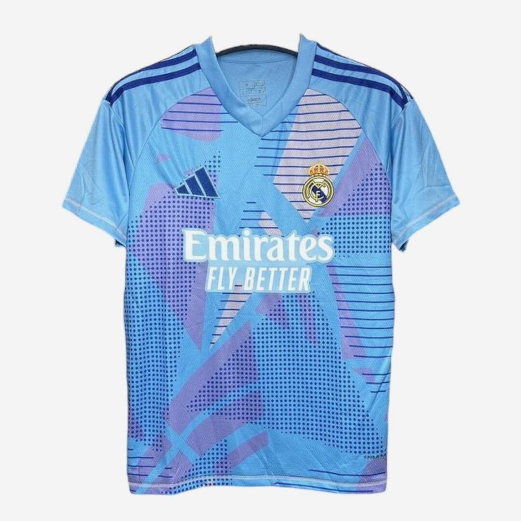 The Retro1999 Real Madrid 2024-25 GK Shirt features light blue fabric with purple and blue geometric design, dark blue trim, club crest, Adidas logo, and white Emirates Fly Better sponsor—a bold pick for La Liga fans.
