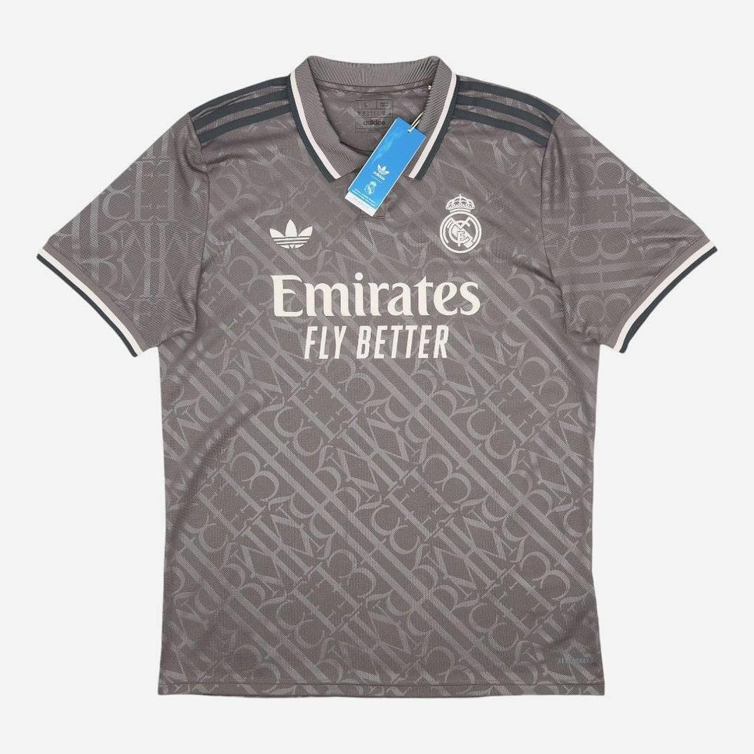 The Retro1999 Real Madrid 2024-25 Third Shirt is a gray soccer jersey with geometric patterns, club and Adidas logos, “Emirates Fly Better” sponsor text, and a blue collar tag—ideal for La Liga fans who want a modern retro look.