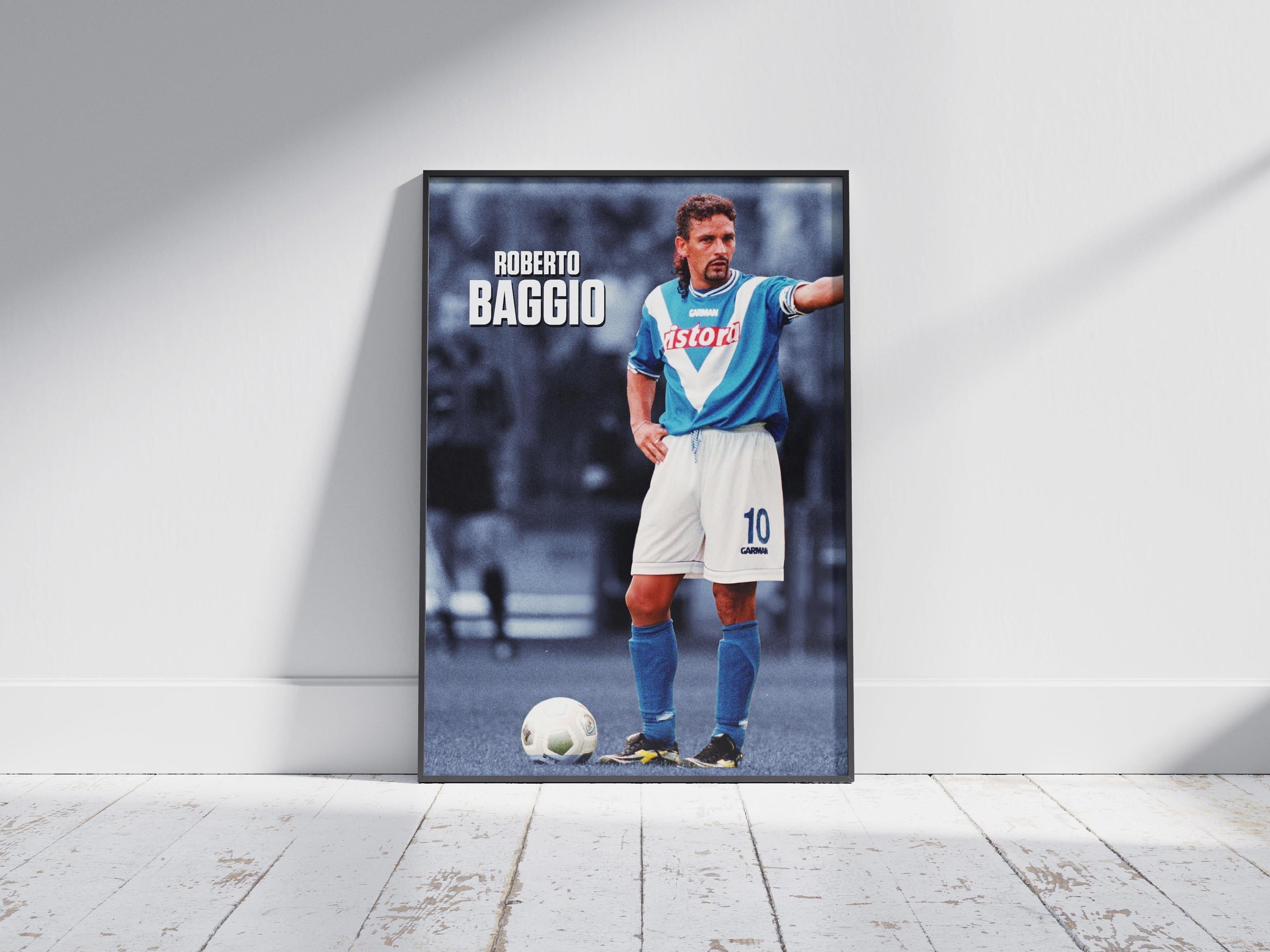 The Retro1999 Roberto Baggio x Brescia Poster showcases the football legend in his iconic blue and white jersey, framed and standing on a wooden floor against a white wall with natural light streaming in.
