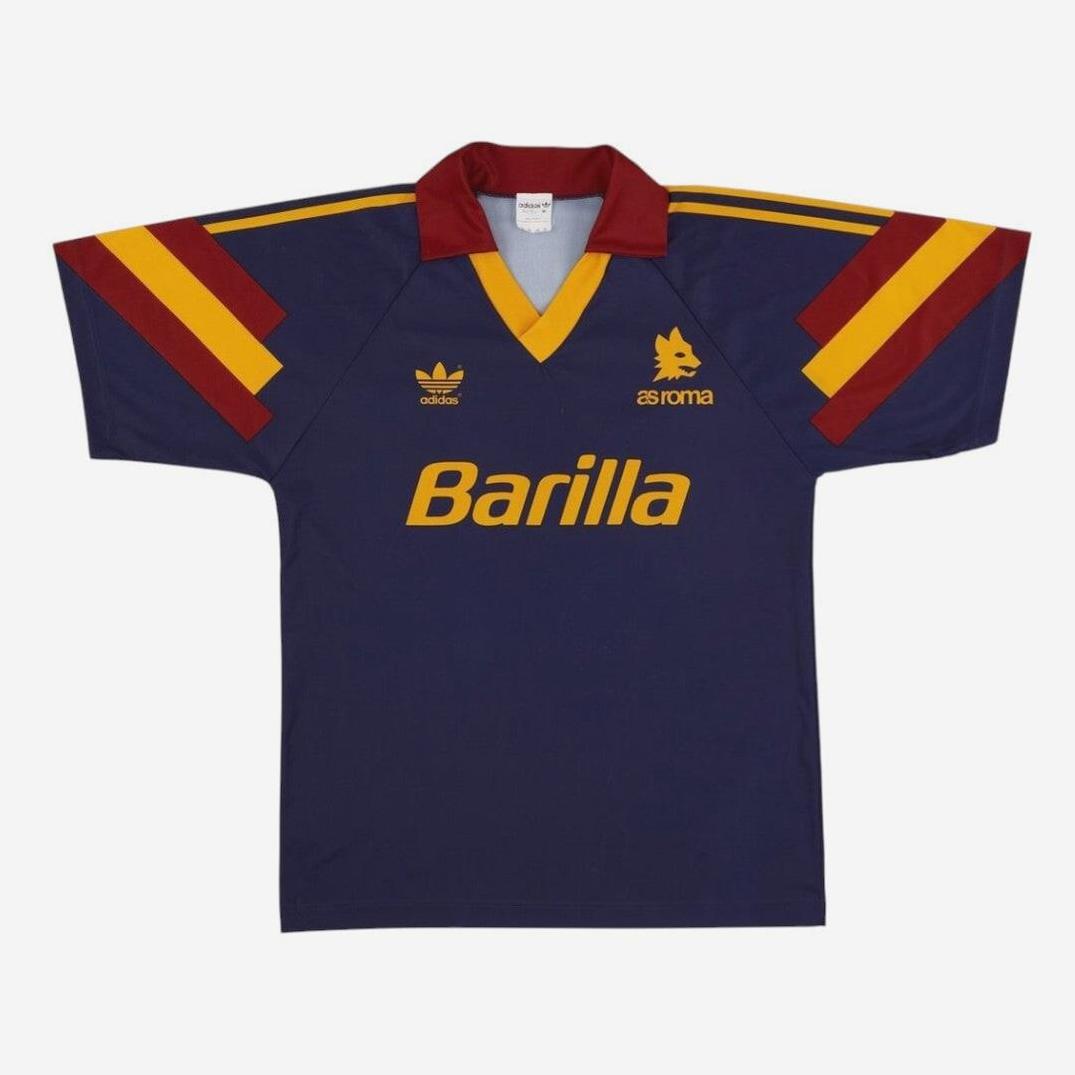 The Roma 1991-92 Third Shirt by Retro1999 features a vintage dark blue design with red and yellow shoulder stripes, red collar, and classic logos—an iconic retro soccer jersey.