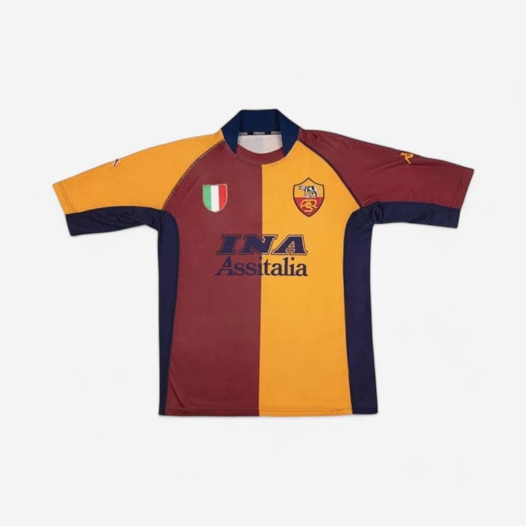 The Retro1999 Roma 2001-02 Home Shirt boasts yellow and maroon halves, navy accents, team crest, INA Assitalia sponsor, and Italian shield patch—a true Serie A collectible shown on a white background.