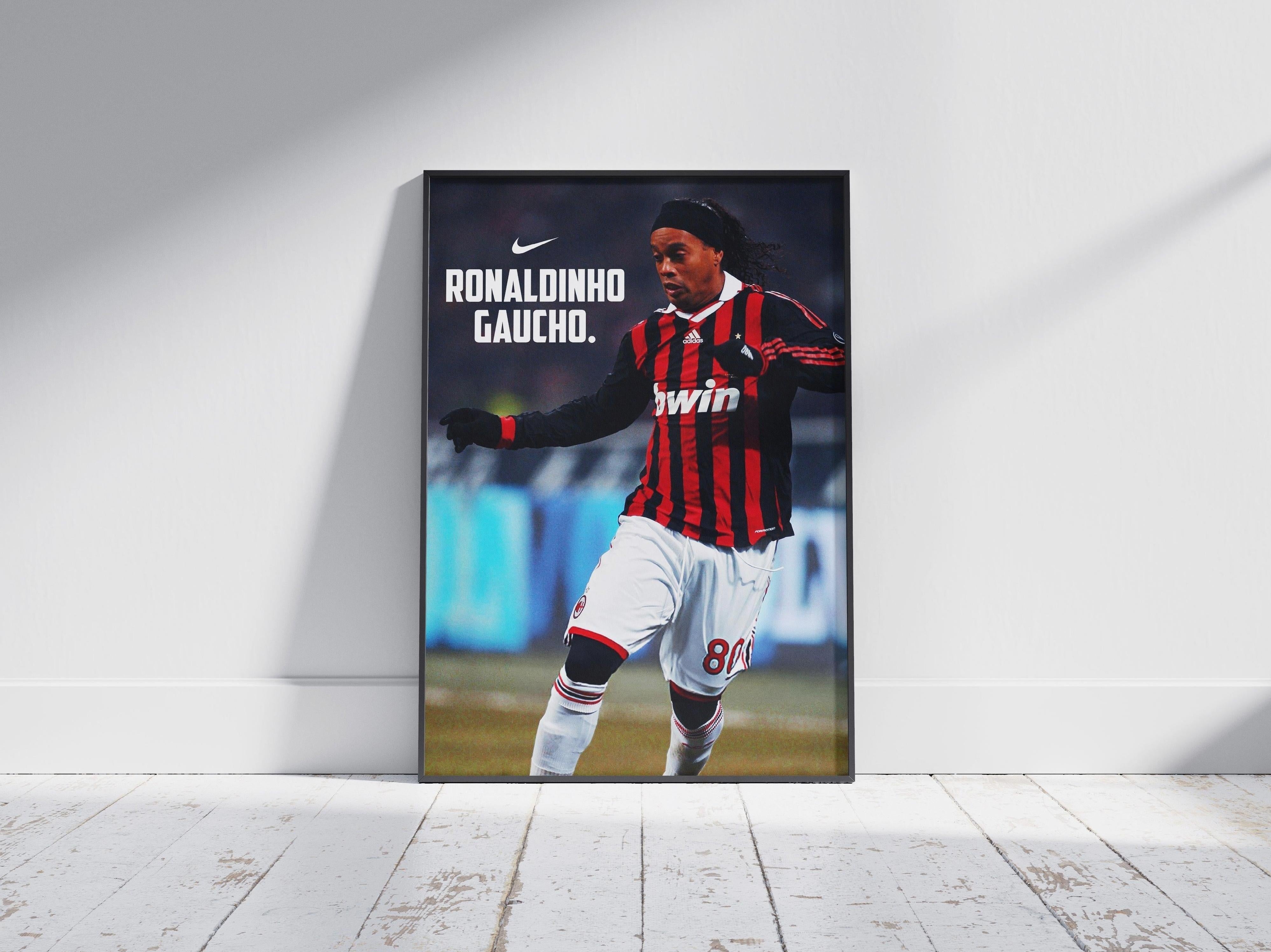 The Retro1999 Ronaldinho Gaucho x AC Milan Poster showcases the soccer legend in an AC Milan jersey with Nike logo, stylishly posed against a white wall and wooden floor—perfect for sports memorabilia collectors.
