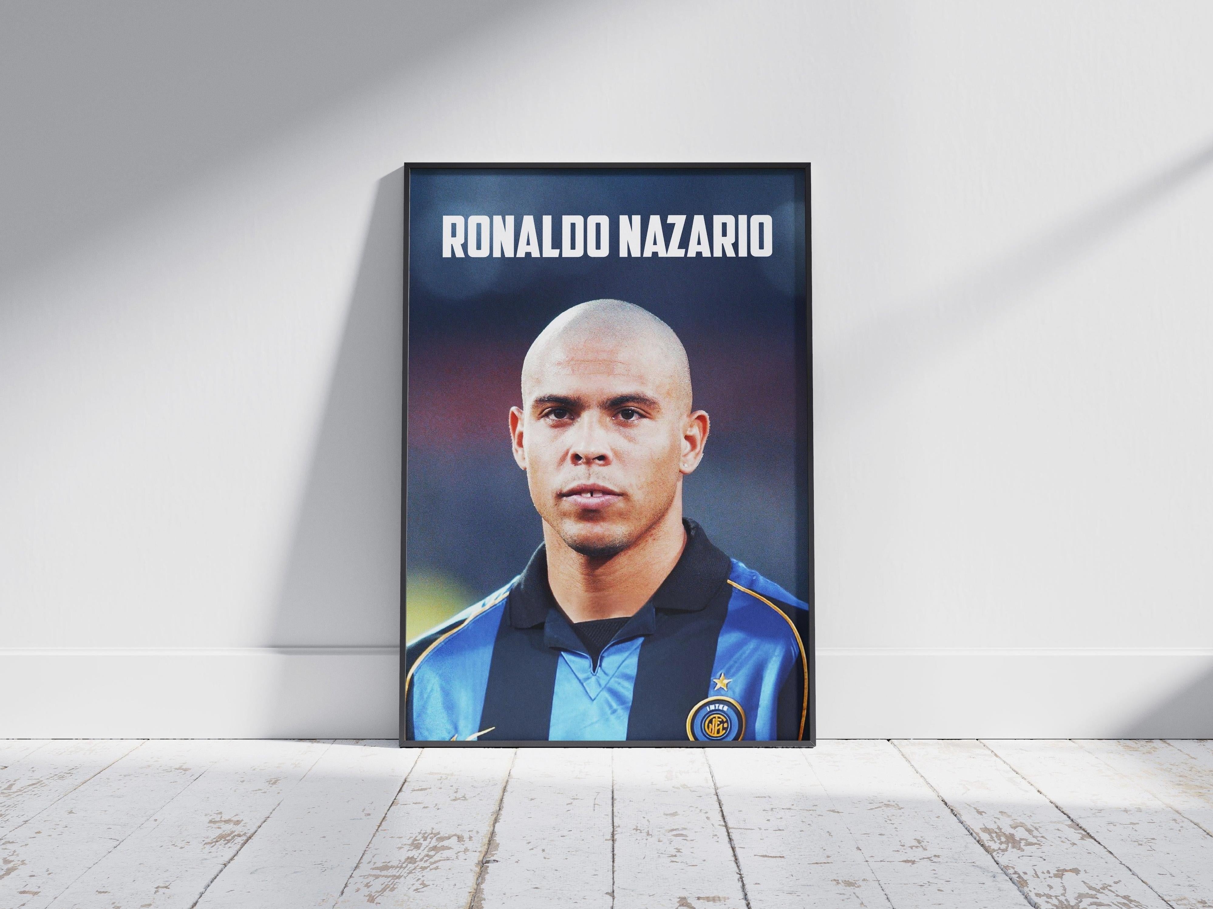 The Ronaldo Nazario Inter Poster by Retro1999 features the football legend in a blue and black striped jersey with his name above, framed and leaning against a wall—a perfect decor piece for football fans.