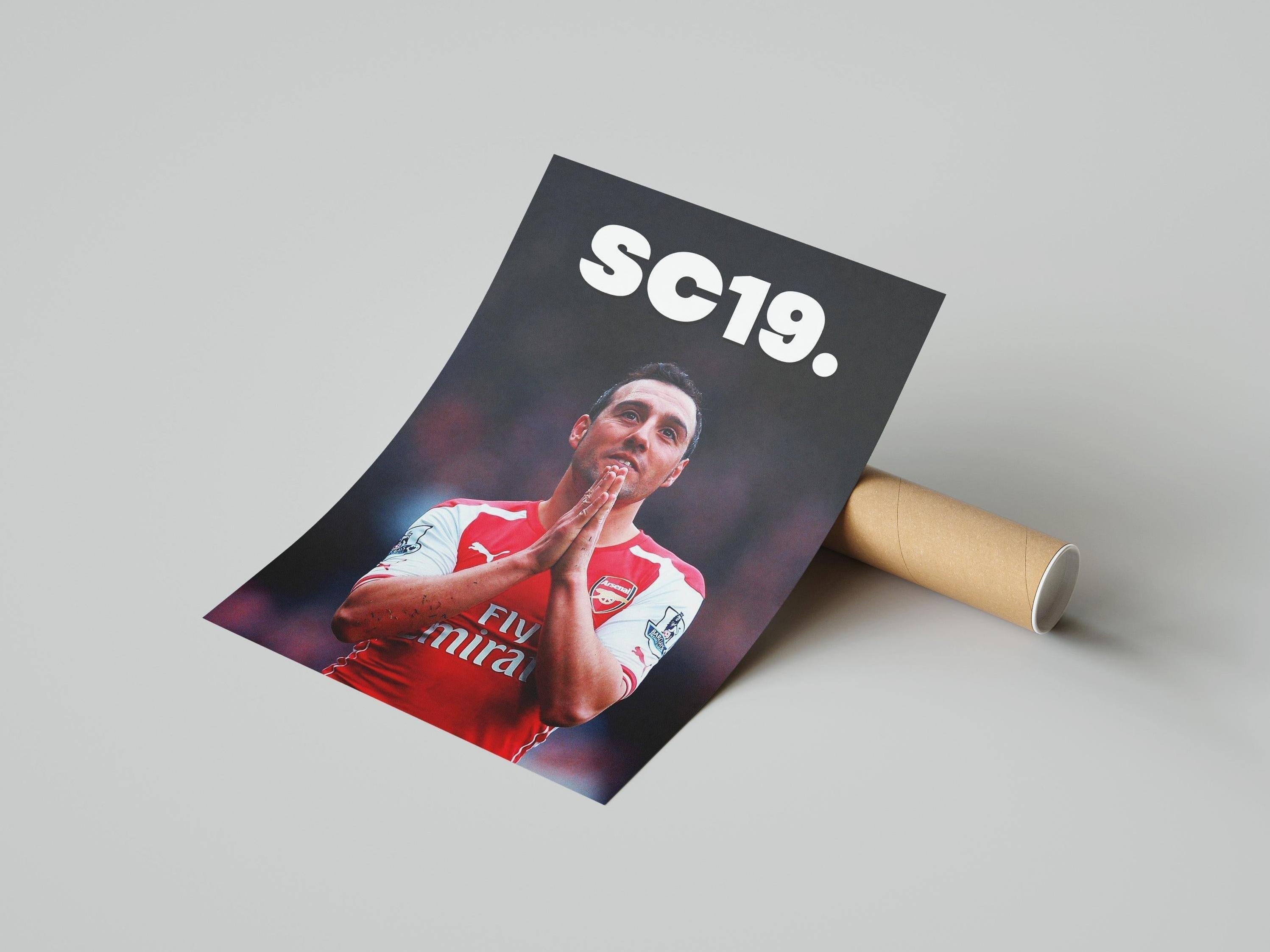 The Retro1999 Santi Cazorla SC19 Poster features the Arsenal star in an iconic pose above bold SC19 text. This partly unrolled print comes with a cardboard tube on a plain light surface—perfect for celebrating football history.