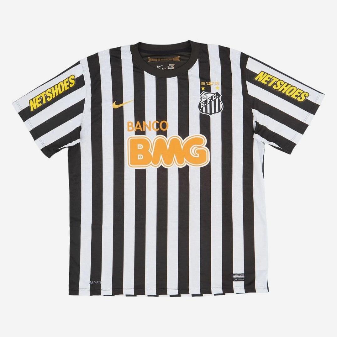 The Santos 2012-13 Away Shirt by Retro1999 features black and white vertical stripes, yellow BANCO BMG and NETSHOES sponsor logos, a Nike logo, club crest, and captures Neymar’s iconic style.