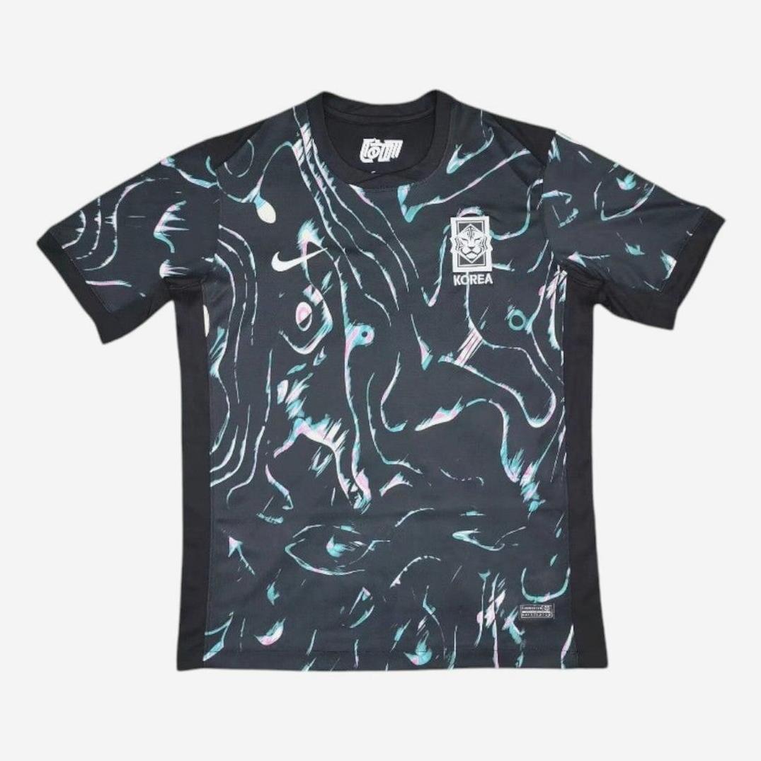 The Retro1999 South Korea 2024 Away Shirt features a black base with abstract teal, pink, and white swirls plus the national crest—combining authentic retro design with classic football kit vibes.