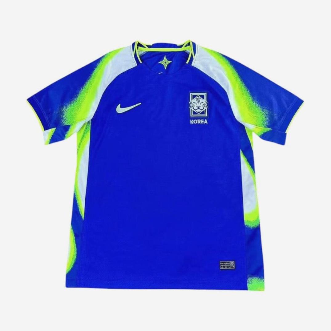 The South Korea 2025-26 Away Shirt by Retro1999 features blue with white and neon green accents, a Nike logo on the right chest, and the Korea FA crest with KOREA text on the left, shown flat on a white background.