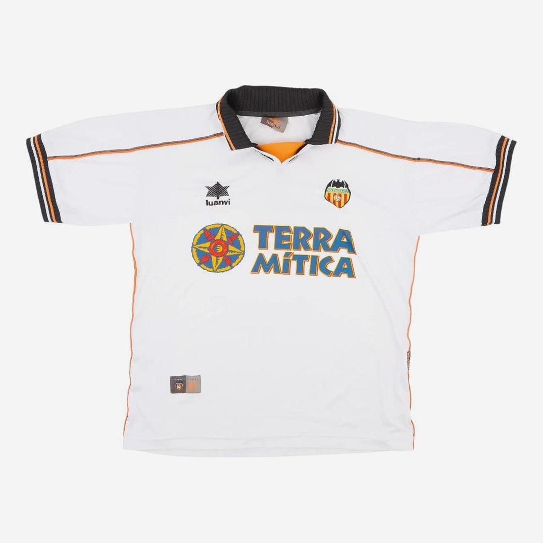 The Retro1999 Valencia CF 1999-00 Home Shirt features a white design with black collar and sleeve trim, “Terra Mítica” sponsor logo, and club crest—an iconic retro piece celebrating the memorable La Liga season.