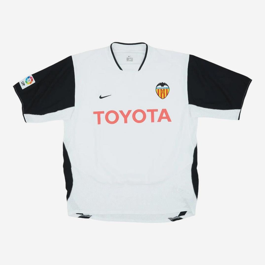 The Retro1999 Valencia CF 2003-04 Home Shirt features a classic white and black design, red TOYOTA sponsor, club crest left chest, Nike logo right chest, and La Liga patch on the left sleeve.