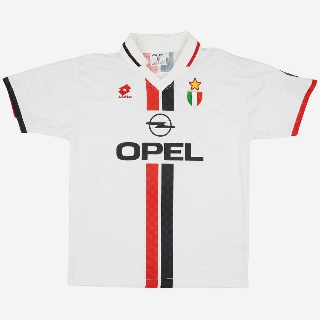 The Retro1999 AC Milan 1995-97 Away Shirt features a white short-sleeve design with red and black stripes, OPEL sponsor, club crest with gold star, Lotto logo, and classic retro accents—ideal for football fans.
