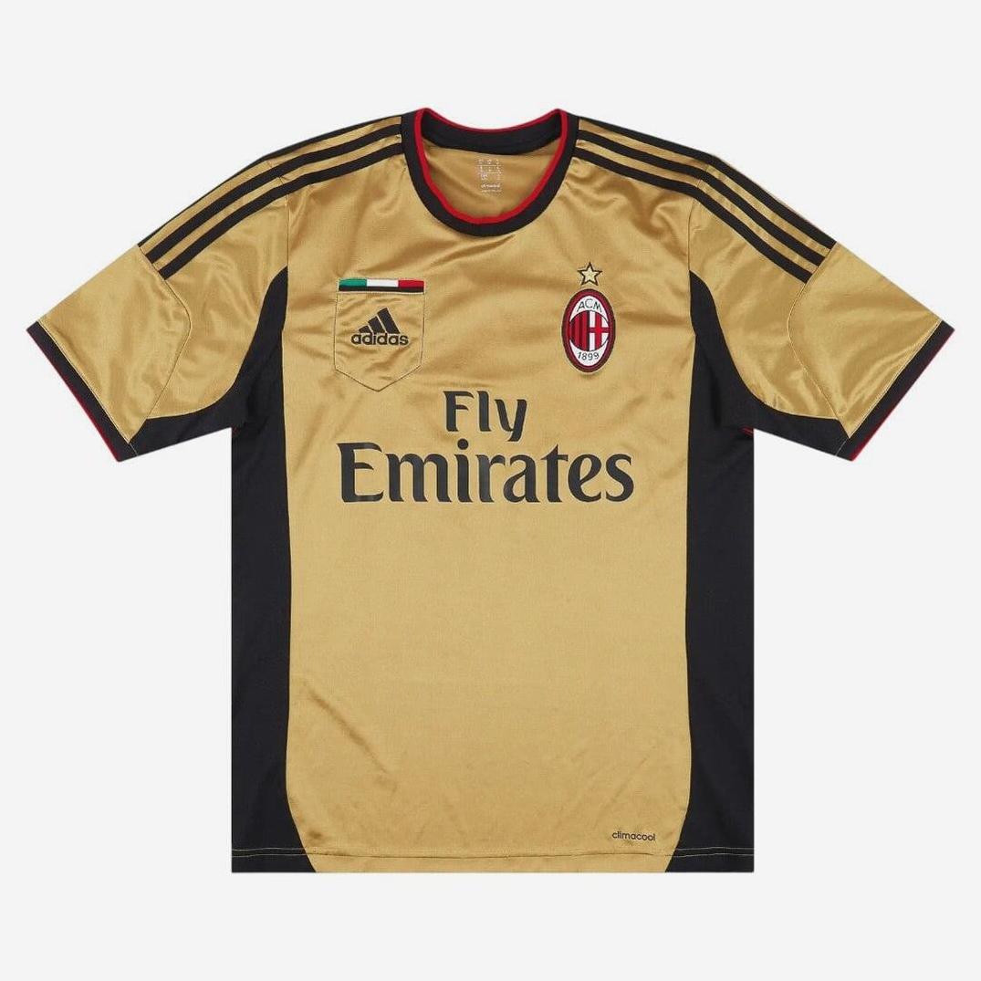 The AC Milan 2013-14 Third Shirt by Retro1999 is a gold and black top for football fans, showcasing the Fly Emirates logo, Adidas emblem, club badge, and an Italian flag patch on a clean white background.