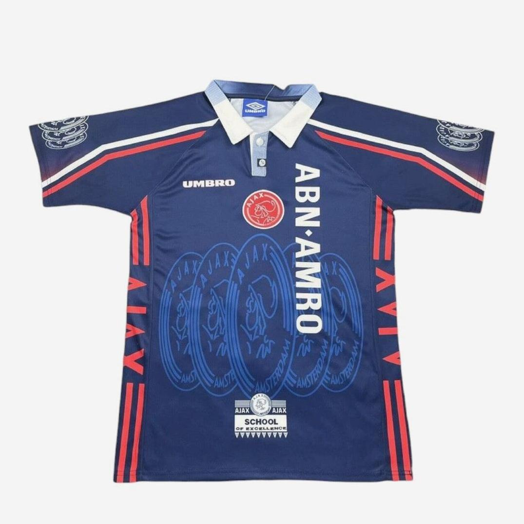 The Ajax 1997-98 Away Shirt by Retro1999 features a classic blue football design with ABN AMRO sponsor, red and white sleeve stripes, Ajax logos, and a white collar with blue insert.