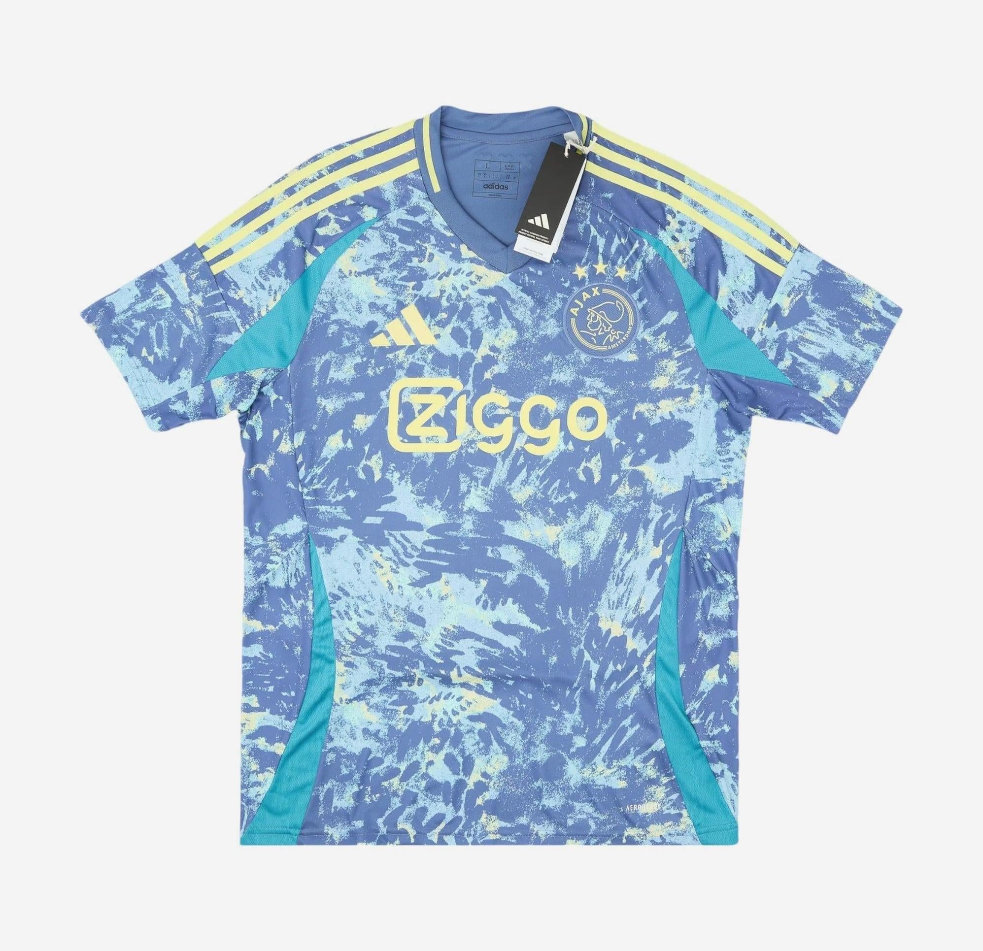 The Ajax 2024-25 Away Shirt by Retro1999 is blue and turquoise with yellow accents, featuring Ziggo sponsor, Adidas logo, and Ajax crest on the front. This retro kit is shown on a plain white background with tags attached.