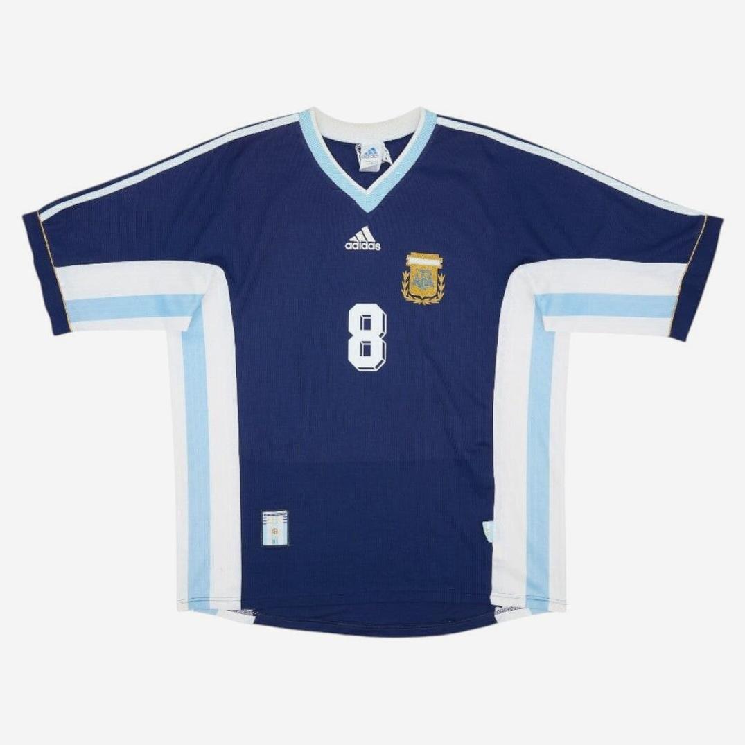 The Retro1999 Argentina 1998 Away Shirt features dark blue with light blue and white sleeve stripes, number 8 on the front, plus Adidas logo and team crest—ideal for retro kit or vintage collections.