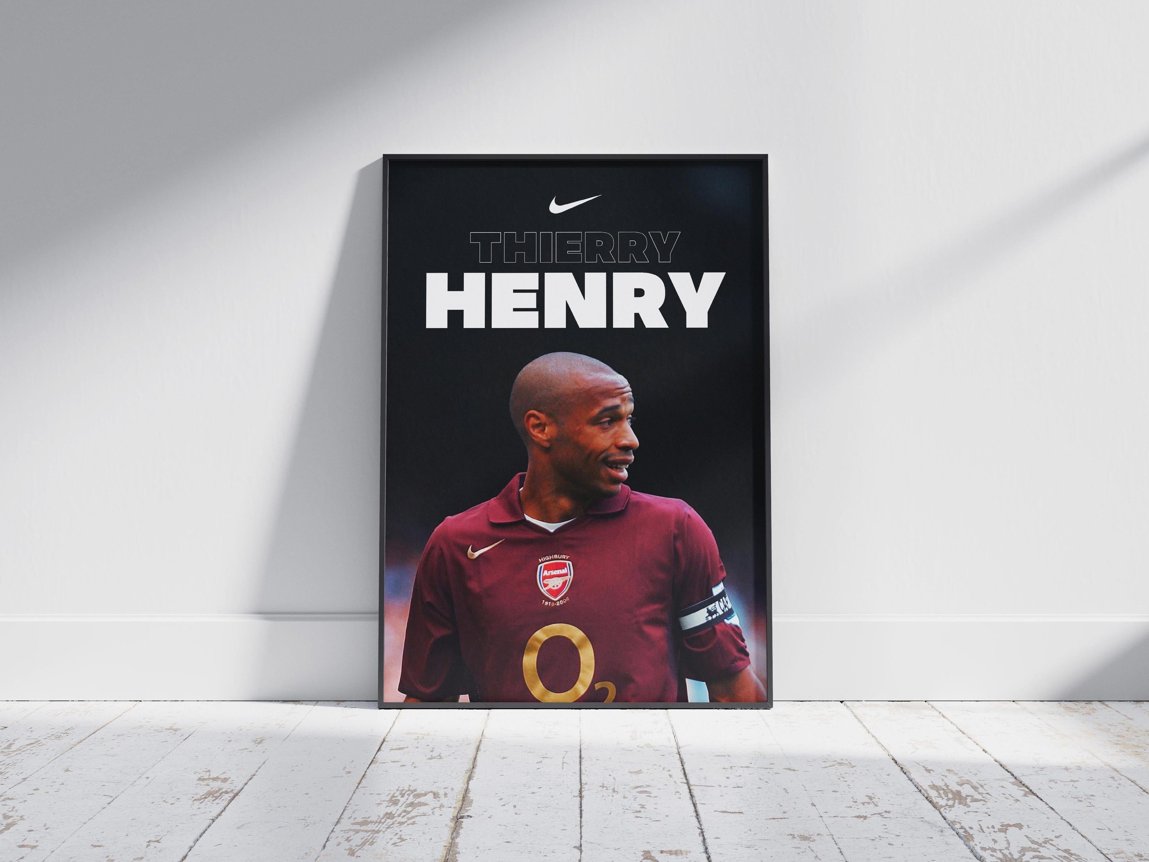 The Arsenal Captain Thierry Henry Poster by Retro1999 is a framed print for true fans, showing the football legend in his prime with Nike branding, stylishly leaned against a white wall on a wooden floor.