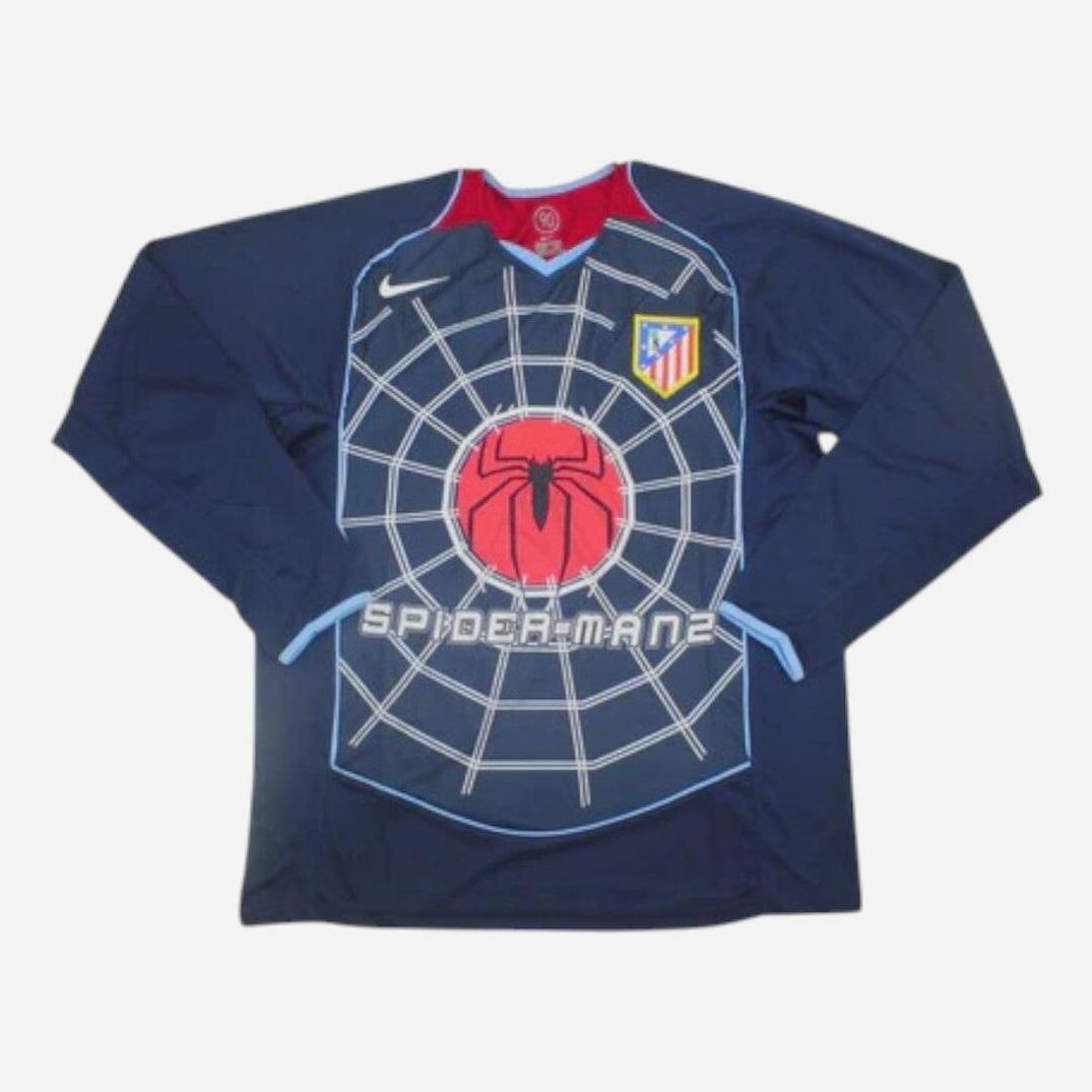 The Retro1999 Atletico Madrid 2004-05 Away Shirt Longsleeve is a navy soccer jersey with a web design, red Spider-Man logo, SPIDER-MAN 2 text, Atlético Madrid crest, and white Nike logo—ideal for retro kit collectors.