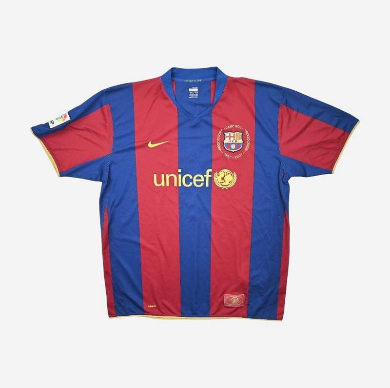 The Retro1999 Barcelona 2007-08 Home Shirt features red and blue stripes, short sleeves, the club’s crest on the left chest, plus yellow Nike and UNICEF logos—a classic design from the Frank Rijkaard era.