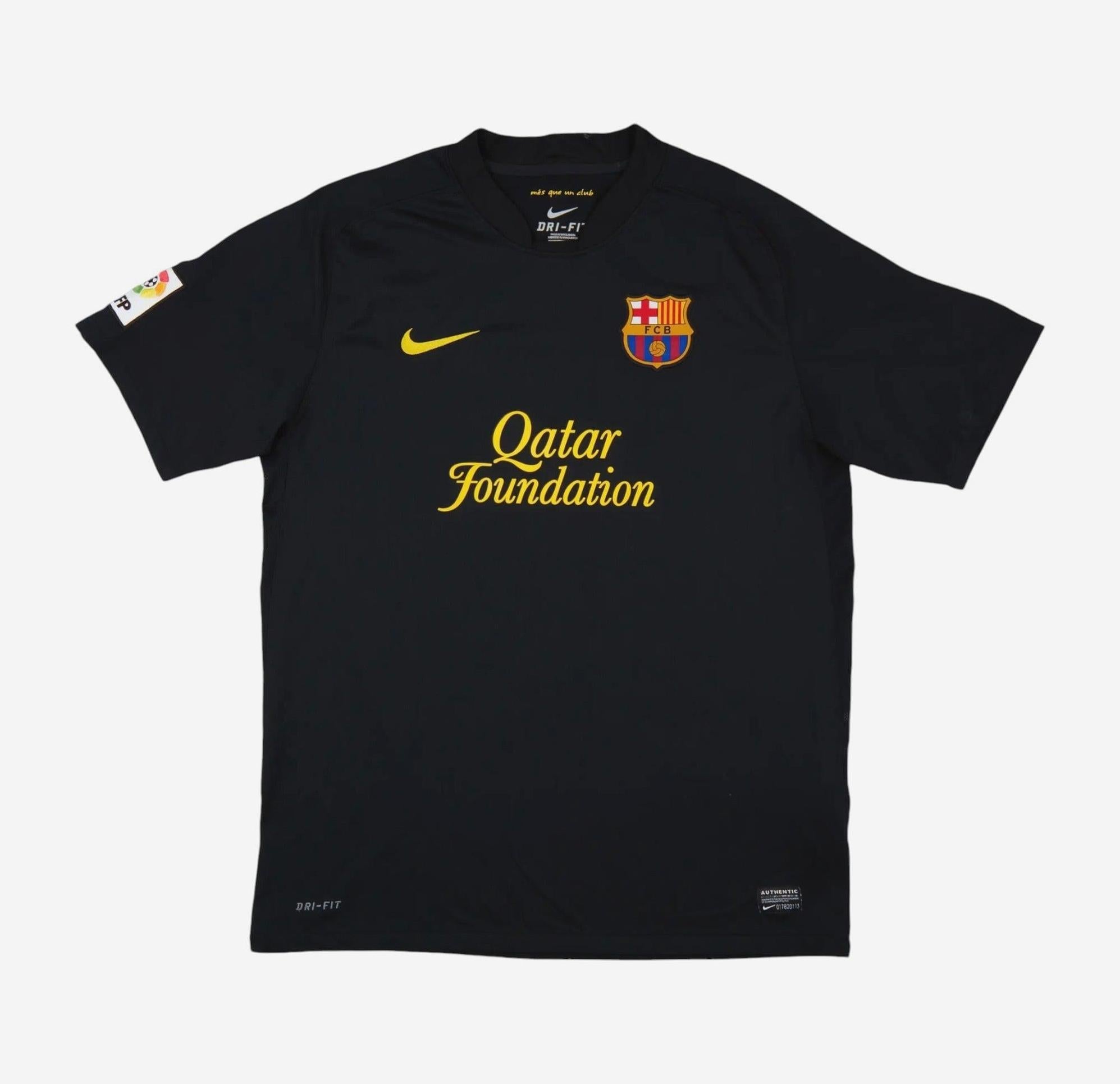 The Retro1999 Barcelona 2011-12 Away Shirt is a black kit featuring the FC Barcelona crest, yellow Nike logo, Qatar Foundation sponsor in yellow, and a La Liga patch on the right sleeve—perfect for true fans.