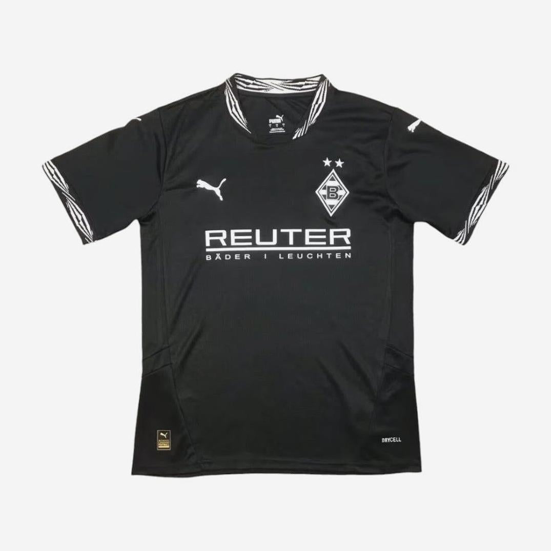 The Borussia Mönchengladbach 2024-25 Third Shirt by Retro1999 features a black design with white accents, “Reuter” sponsor, Puma logos, and team crest—ideal for fans who love classic retro Bundesliga styles.