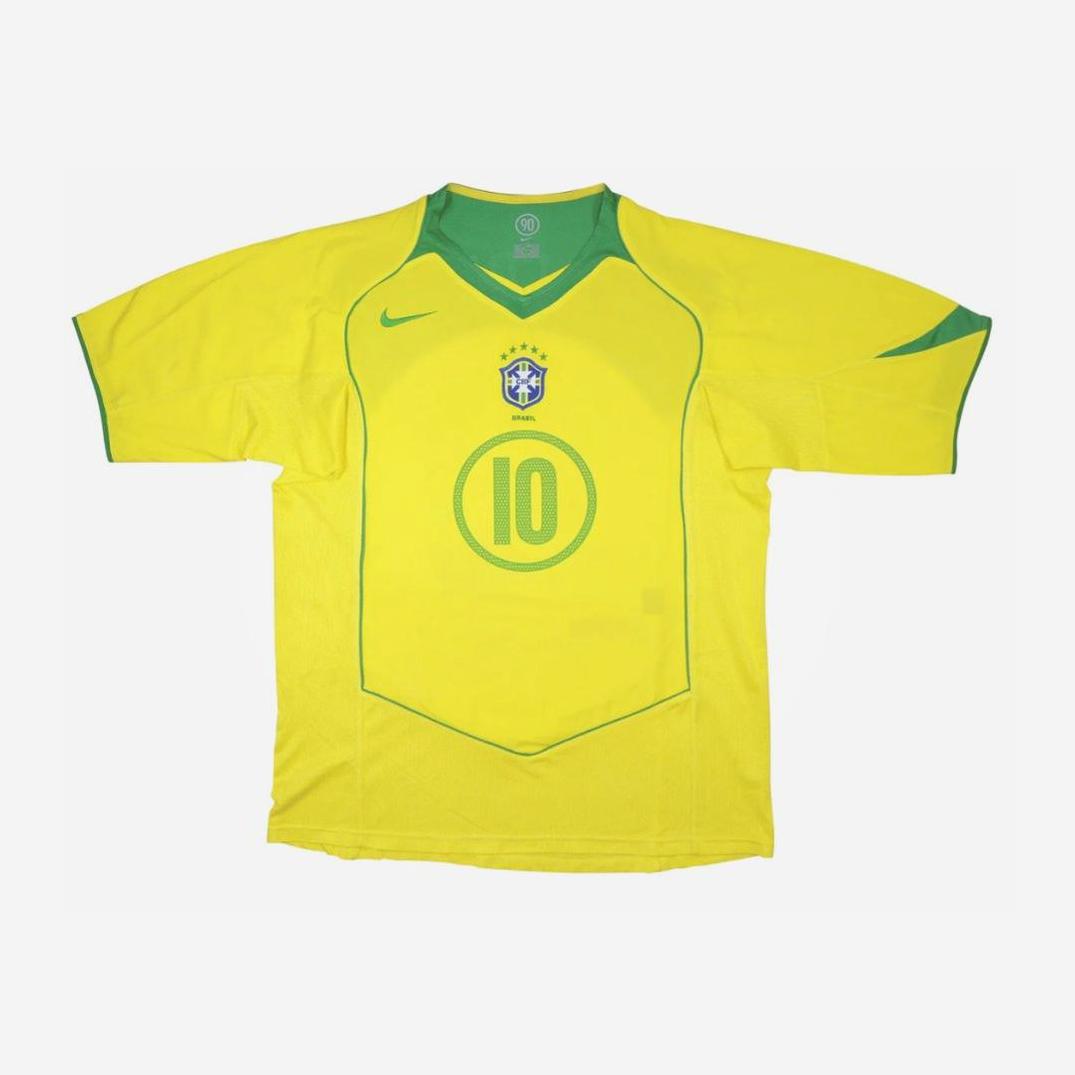 The Retro1999 Brazil 2004 Home Shirt features yellow fabric with green trim, number 10 on the front, the team crest, Nike logo, short sleeves, and a green collar—ideal for any fan of Brazilian football.