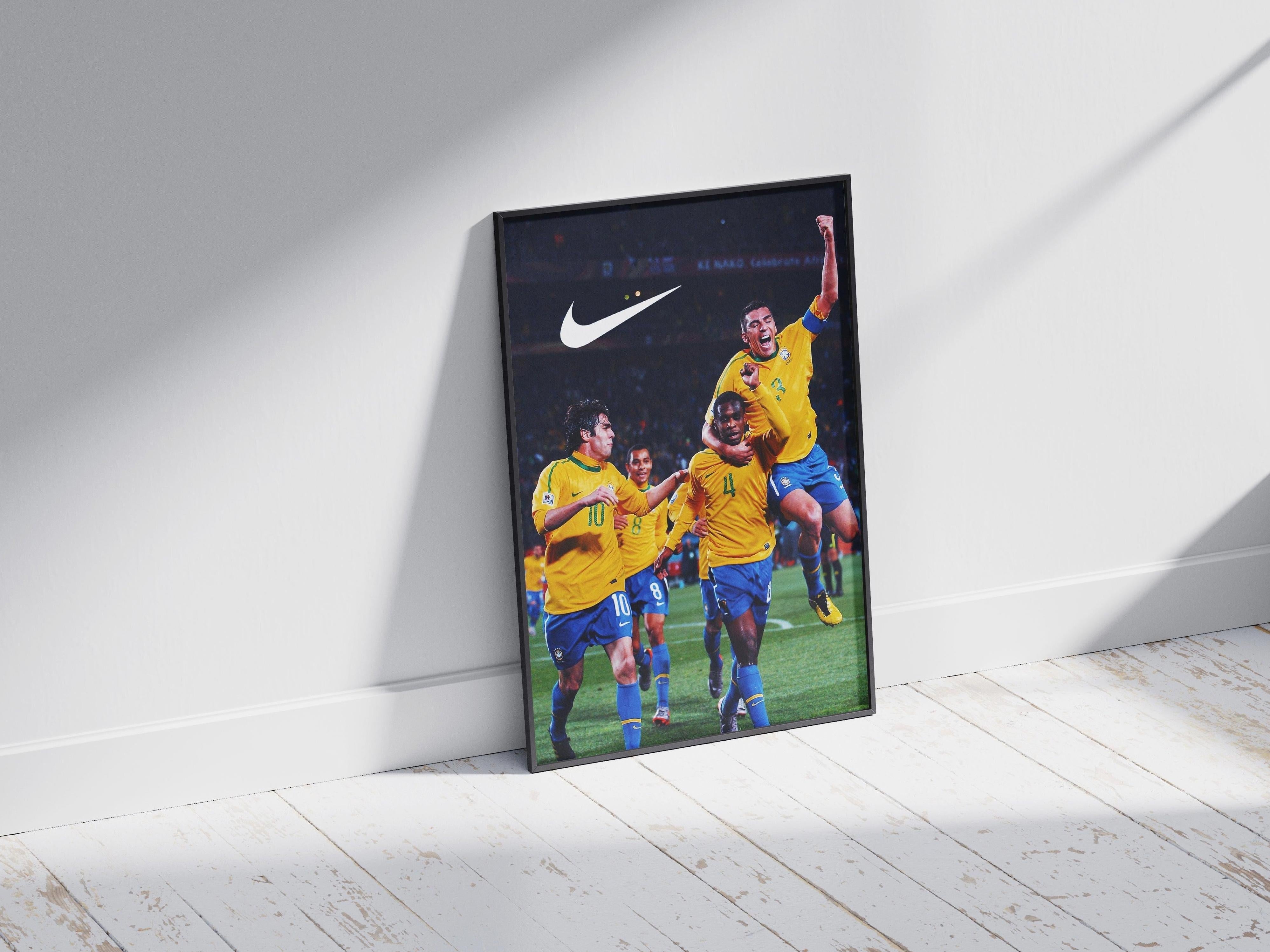 The Brazil 2010 World Cup Poster by Retro1999 features Brazilian players in yellow jerseys celebrating on the field, framed and leaning against a white wall with sunlight and shadows—perfect for fans reminiscing about legendary football moments.