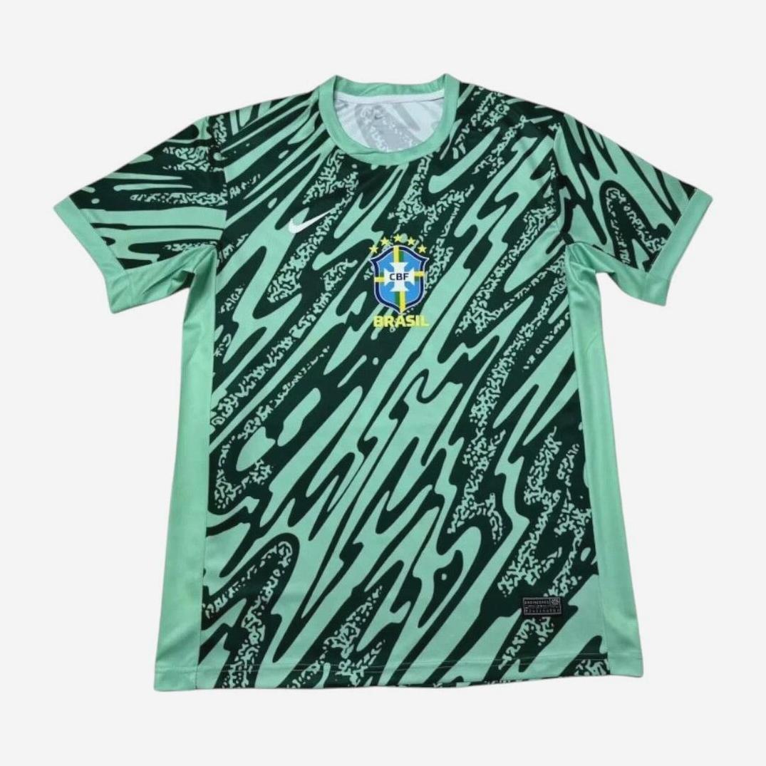 The Retro1999 Brazil 2024/25 Training Shirt features green and light green abstract zigzag patterns and a CBF Brazil crest on the chest, delivering standout retro kit vibes—displayed here on a clean white background.