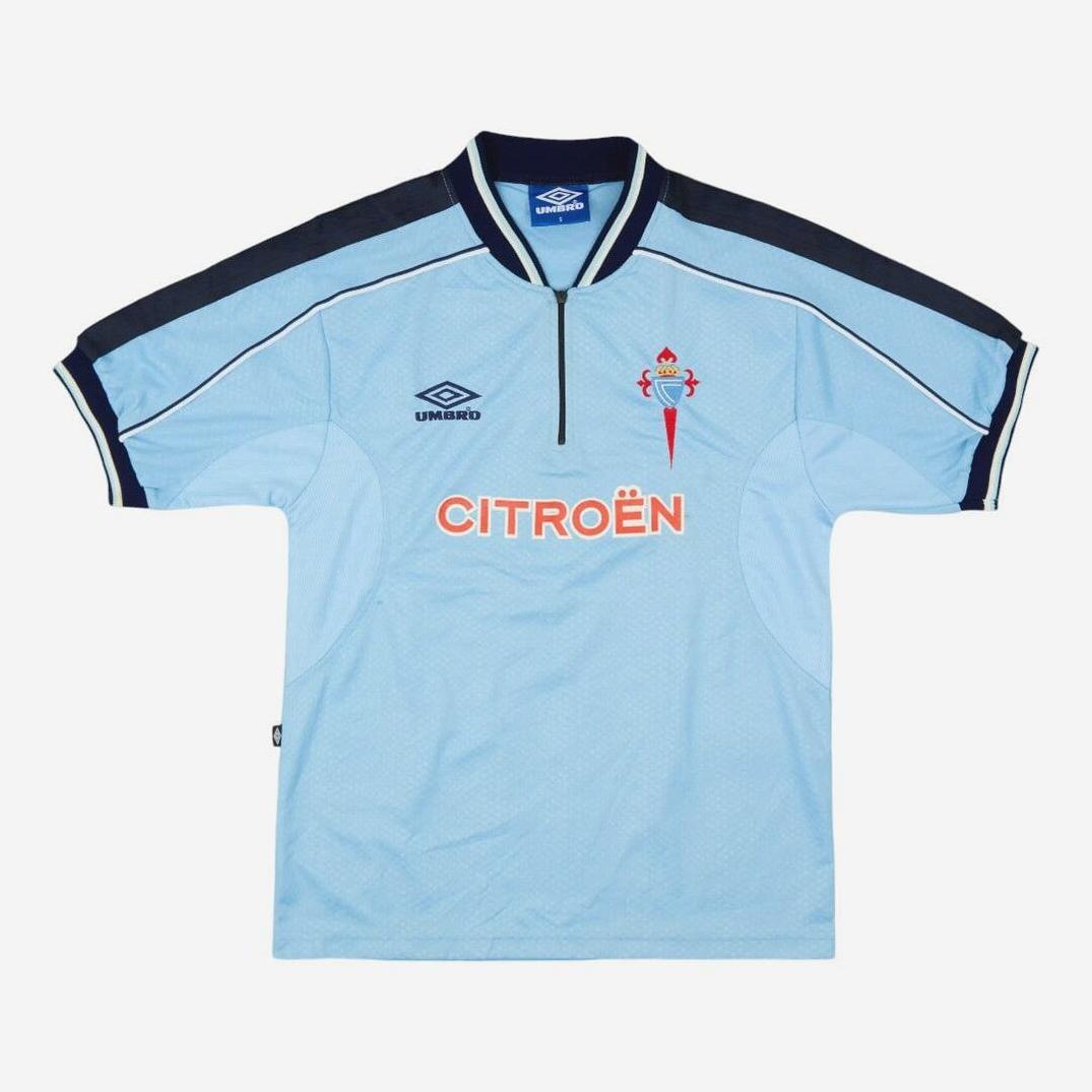 Ideal for Celta Vigo fans, the Retro1999 Celta Vigo 1999-01 Home Shirt is a light blue jersey with dark blue shoulders and collar, featuring the club crest, Umbro logo, and orange Citroën sponsor on the front.