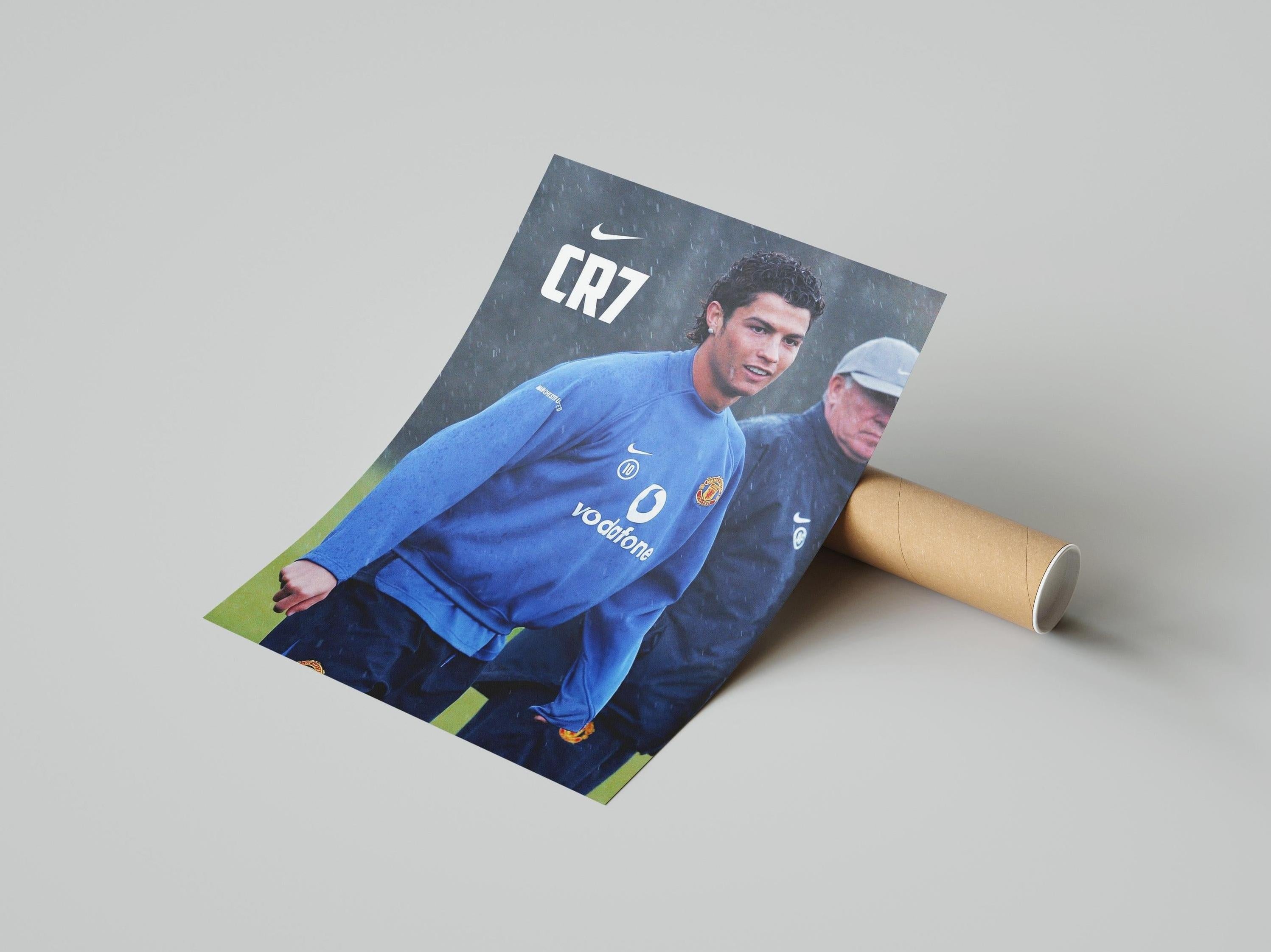 The Retro1999 CR7 x Sir Alex Poster showcases a footballer in a blue Manchester United training kit, with CR7 and Nike logos on top—a tribute to Cristiano Ronaldo and club history on a plain light background.