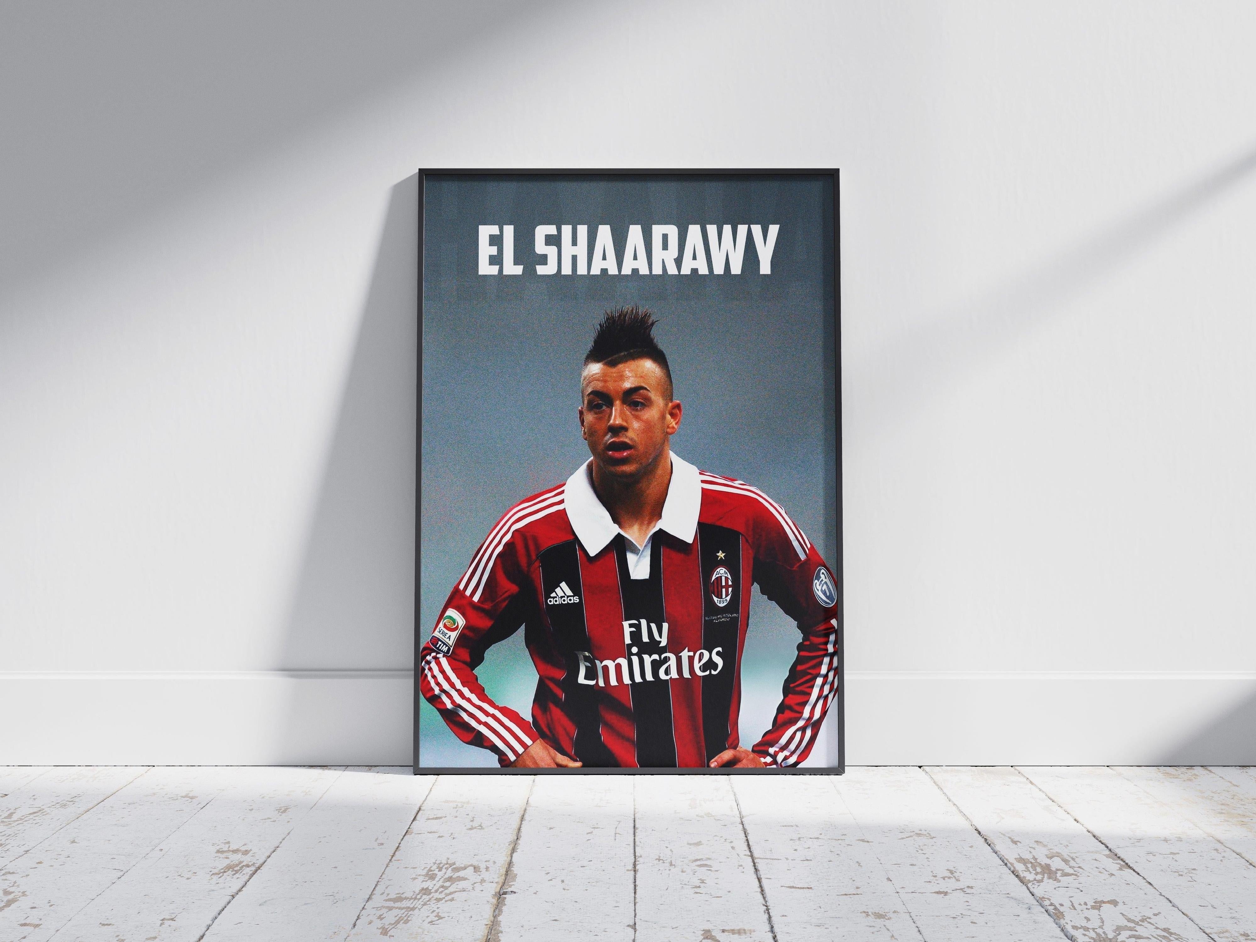 The Retro1999 El Shaarawy x AC Milan Poster, showing the footballer in the classic AC Milan jersey with EL SHAARAWY above, is framed and leans against a white wall on a white floor as soft shadows fall across the scene.