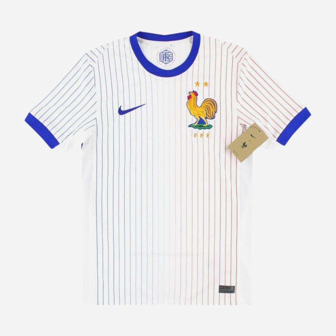 The France 2024 Away Shirt by Retro1999 is white with thin blue and red stripes, blue collar and cuffs, a blue logo, and a rooster crest with two stars. A brown tag is attached to one sleeve.