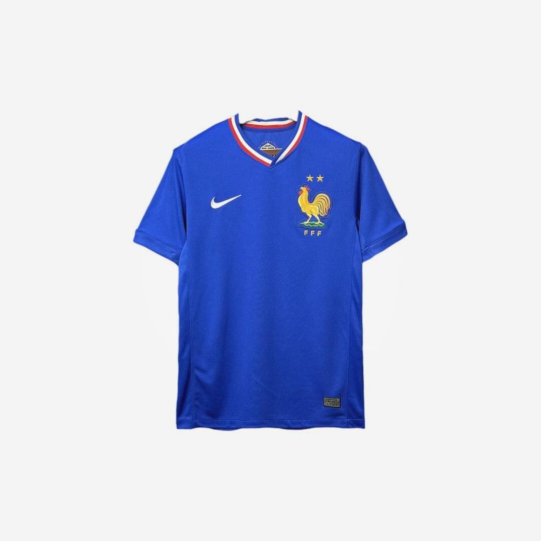 The Retro1999 France 2024/25 Home Shirt is blue with a yellow rooster crest, two stars, a Nike logo, and red-white-blue collar trim. This retro kit is shown on a plain white background.