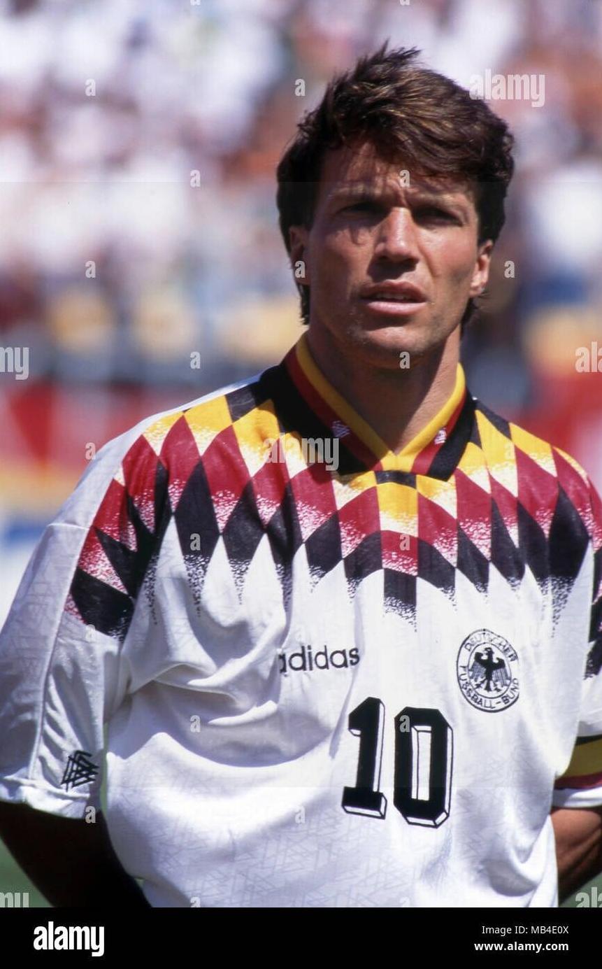 A soccer player wears the Retro1999 Germany 1994 Home Shirt—a classic jersey showcasing the iconic diamond pattern, number 10, and celebrating German football history.