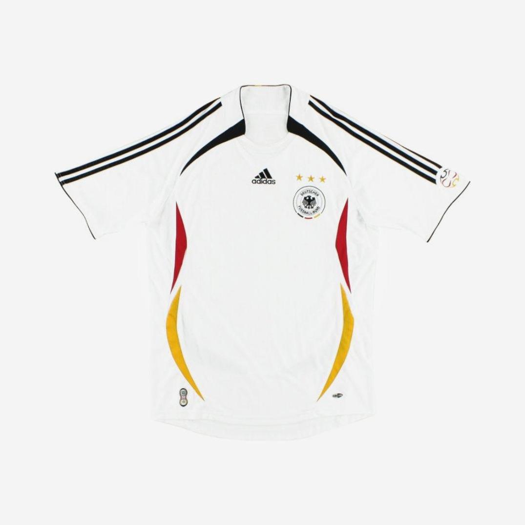 The Germany 2006 Home Shirt by Retro1999 features a black Adidas logo, three gold stars, the team crest, and black, red, and yellow accents—an iconic retro kit for fans.