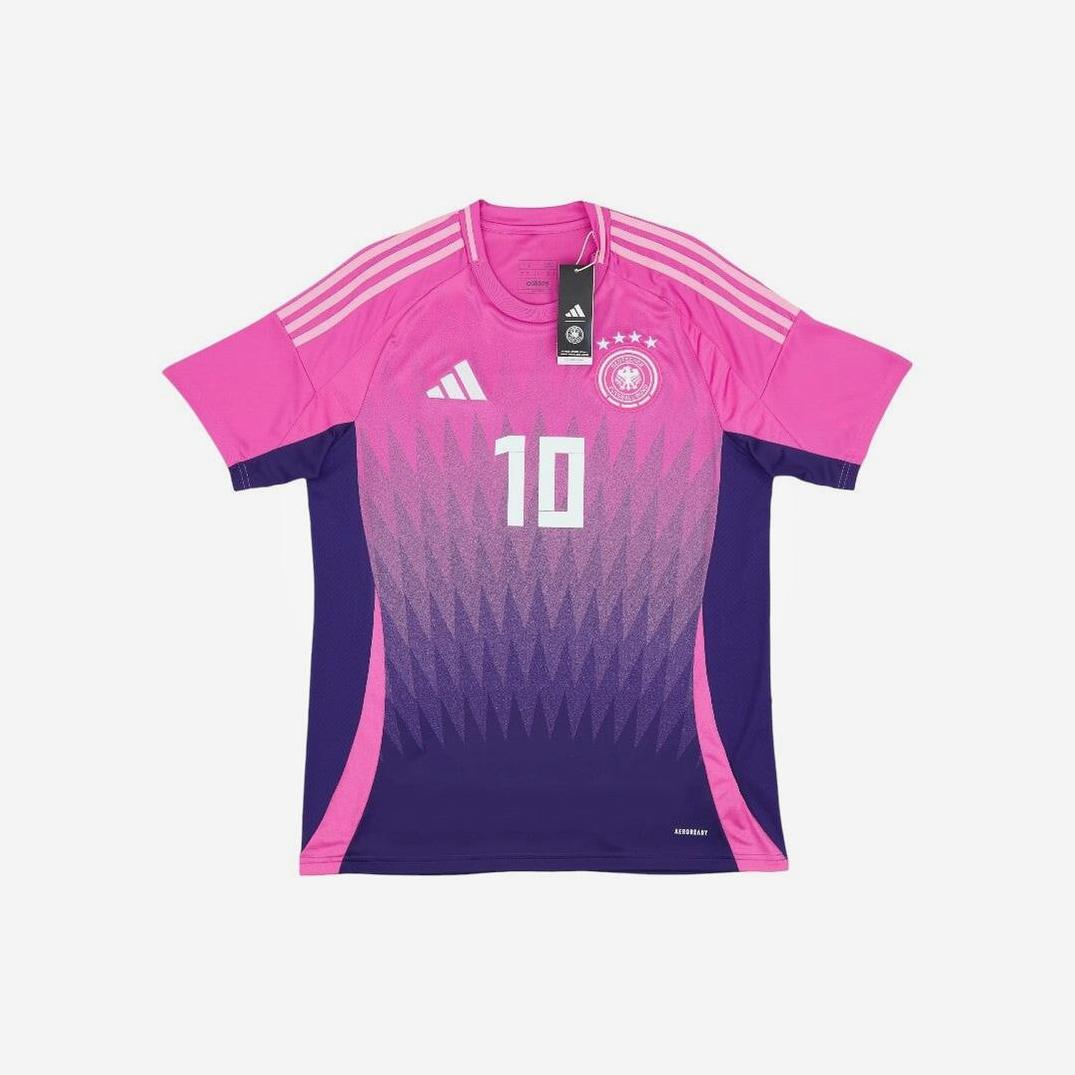 A pink and purple Germany 2024 Away Shirt by Retro1999 with number 10, gradient geometric design, and chest badge. This retro kit offers premium comfort and arrives brand new with tags attached.