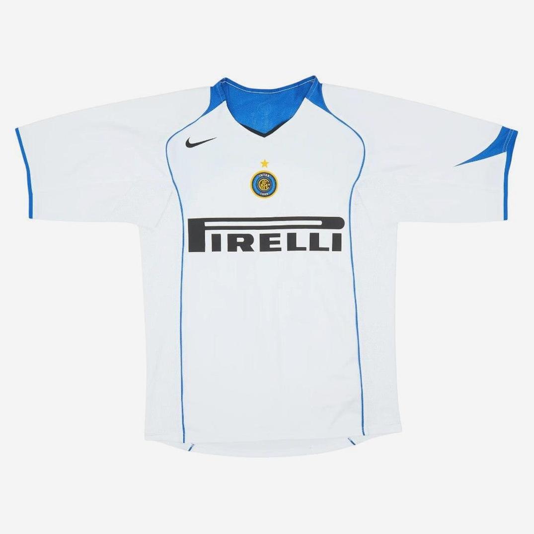 The Inter Milan 2004-05 Away Shirt by Retro1999 is a white top with blue accents, club crest, black Nike logo, and bold Pirelli sponsor—a classic retro football kit ideal for dedicated fans.