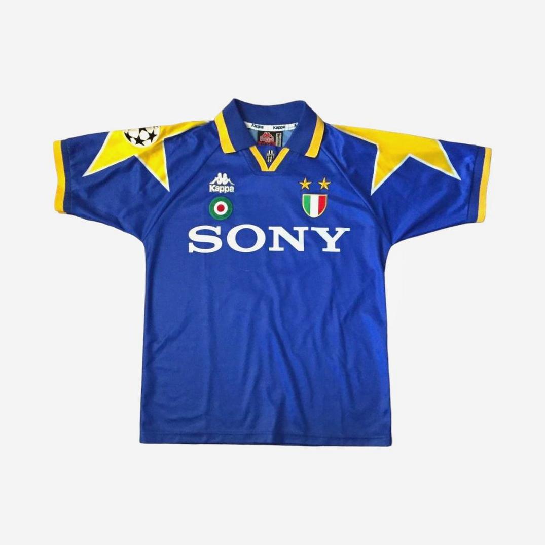 The Juventus 1995-96 Away Shirt by Retro1999 features blue fabric, yellow star shoulder patterns, SONY sponsor, Kappa logos, two gold stars, and an Italian league badge—a classic kit from the iconic Champions League Final.