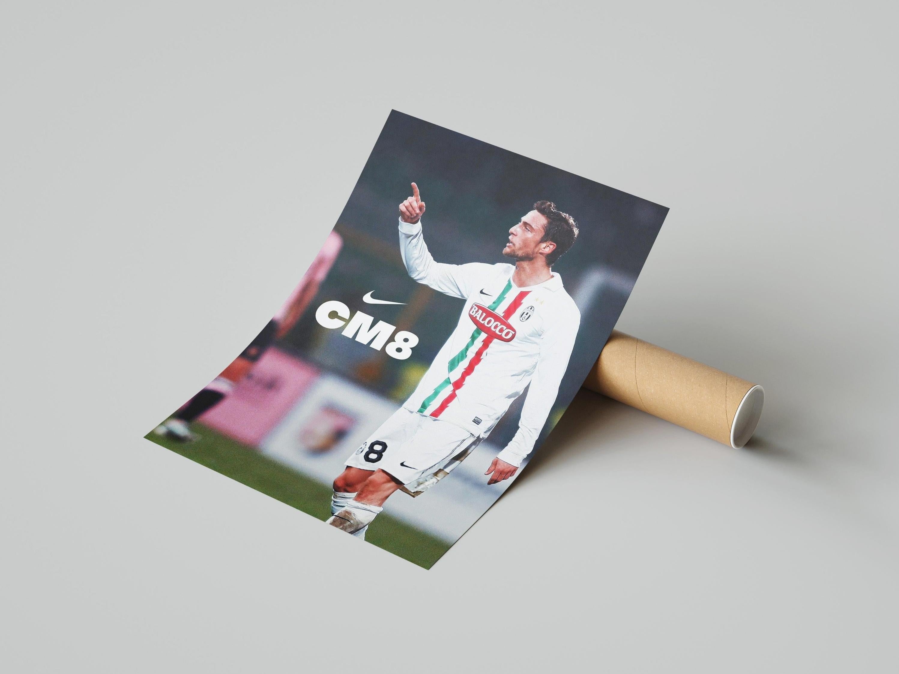 The Retro1999 Marchisio CM8 Poster shows the Juventus star in a white kit with CM8 and Nike logo, pointing upwards; rolled up with a cardboard tube on a light gray background—ideal for football fans.
