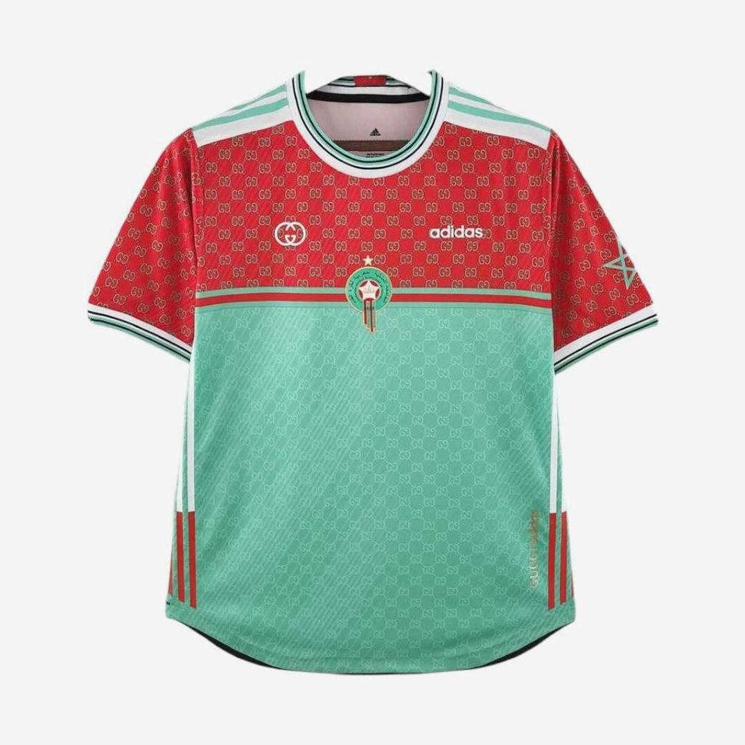 The Retro1999 Morocco 2022 Away Shirt Special features red patterned shoulders and sleeves, a mint green geometric body, and the Moroccan emblem—perfect for fans seeking stylish football apparel.