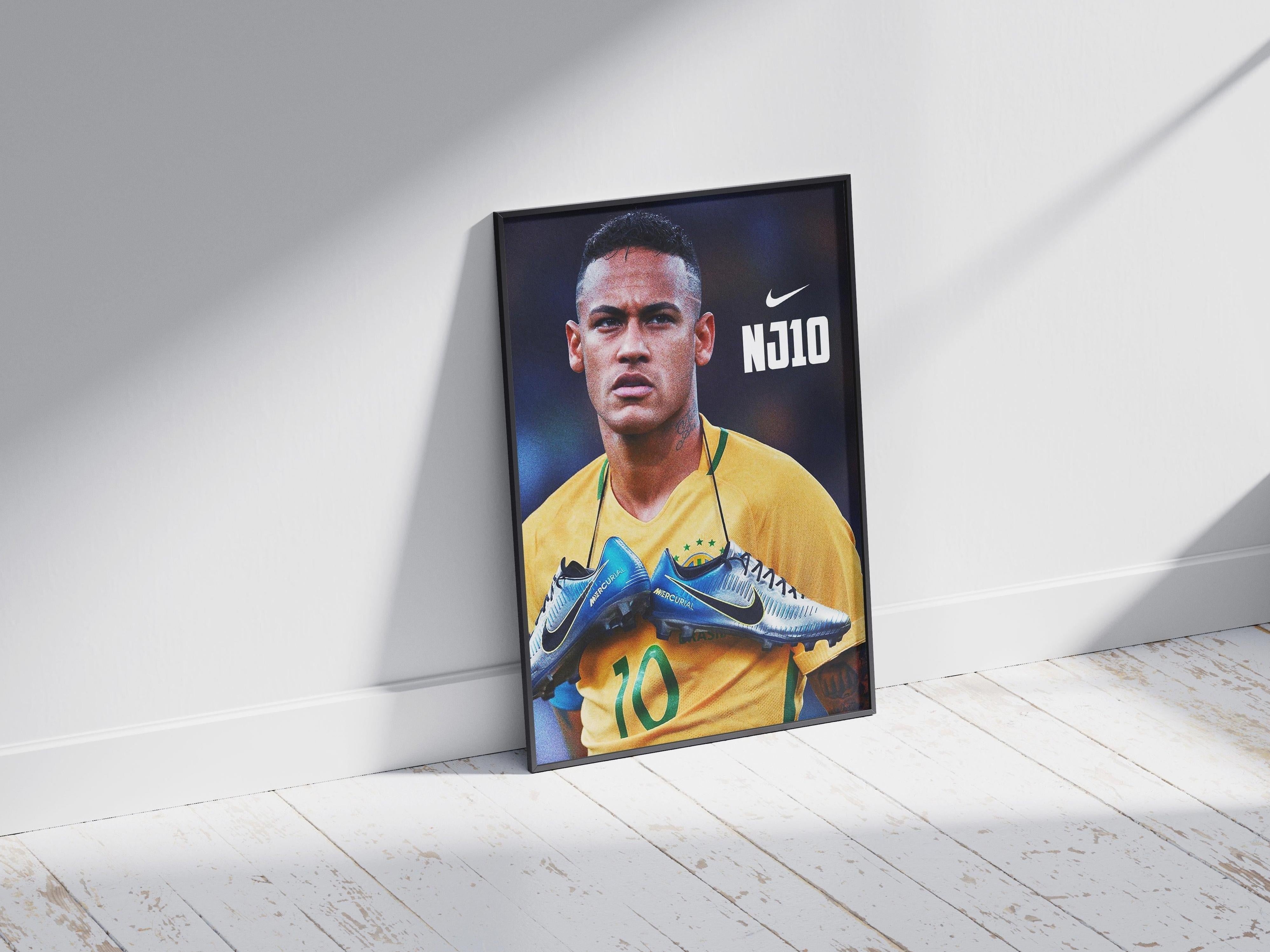 The Neymar NJ10 Poster by Retro1999 features Neymar in a yellow jersey with green collar and #10, holding a blue Mercurial boot around his neck, with NJ10 text and the Nike logo, framed against a white wall on a wooden floor.