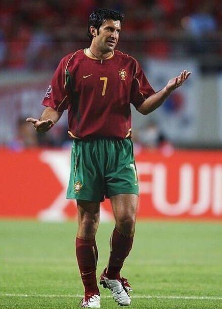 A soccer player in a Retro1999 Portugal 2006 Home Shirt with the number 7 celebrates on the field, highlighting classic national football shirt style.