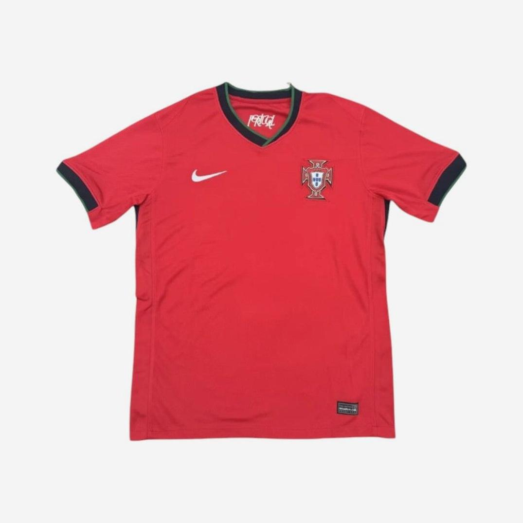 The Retro1999 Portugal 2024 Home Shirt is red with green trim, featuring a Nike swoosh on the right chest and the Portuguese team crest on the left, inspired by classic retro kits and displayed on a plain white background.