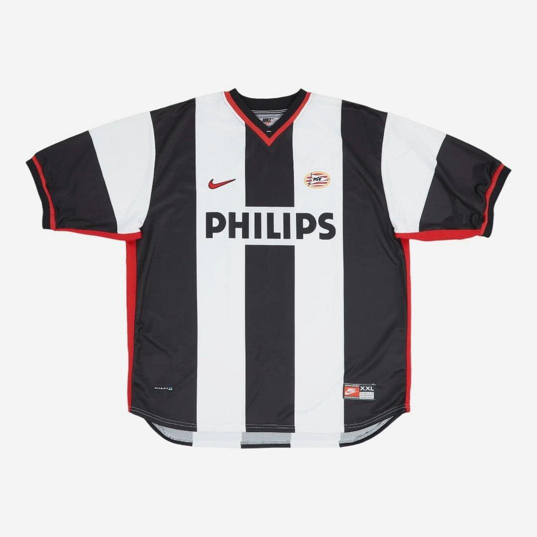 The PSV 1998-99 Away Shirt by Retro1999 features black and white stripes, red accents, a red Nike logo, the PSV Eindhoven badge, and PHILIPS across the chest. Displayed on a plain white background.