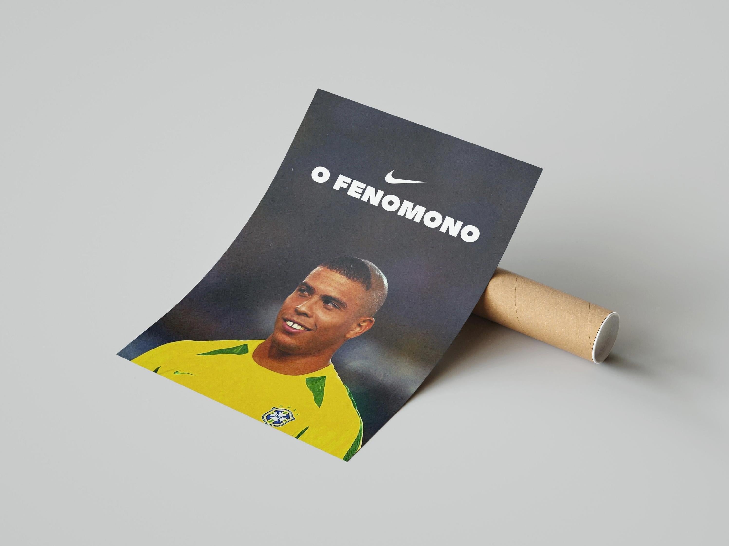 The Retro1999 R9 O Fenômeno Poster showcases a smiling Ronaldo in Brazils yellow jersey with the Nike logo, partially rolled in a cardboard tube against a light gray background.