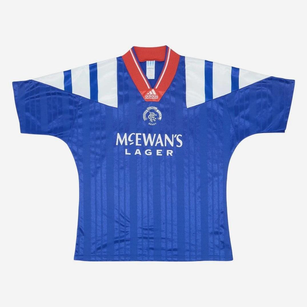 The Retro1999 Rangers F.C. 1992-94 Home Shirt features blue and white stripes, red collar, MC EWAN’S LAGER sponsor, and iconic crest—an unforgettable football classic displayed on a plain white background.
