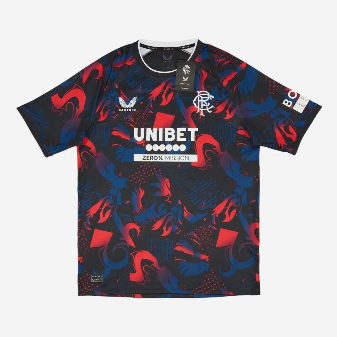 The Retro1999 Rangers F.C. 2024-25 Third Shirt is a navy blue jersey with bold red and blue abstract patterns, white collar trim, UNIBET and BOXT sponsor logos, club crest on the chest, and tags on the collar.